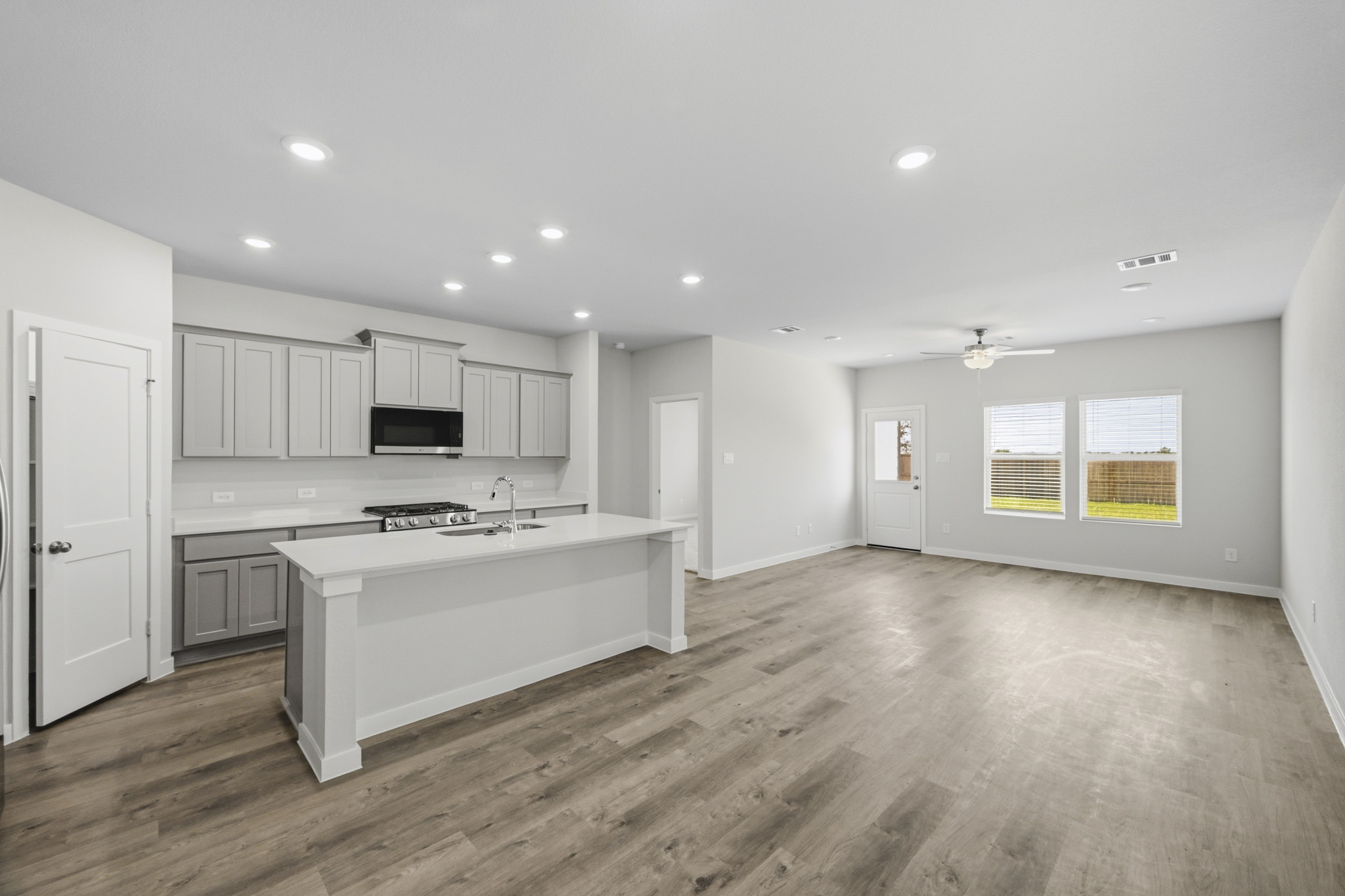 A large kitchen with white cabinets.