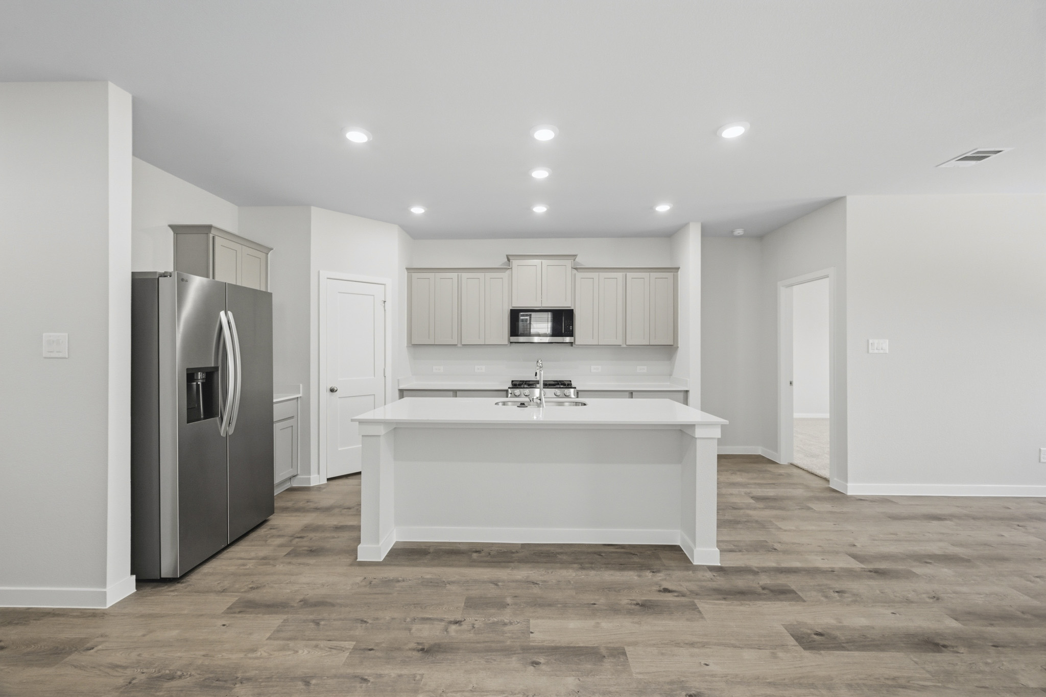 A kitchen with white cabinets.