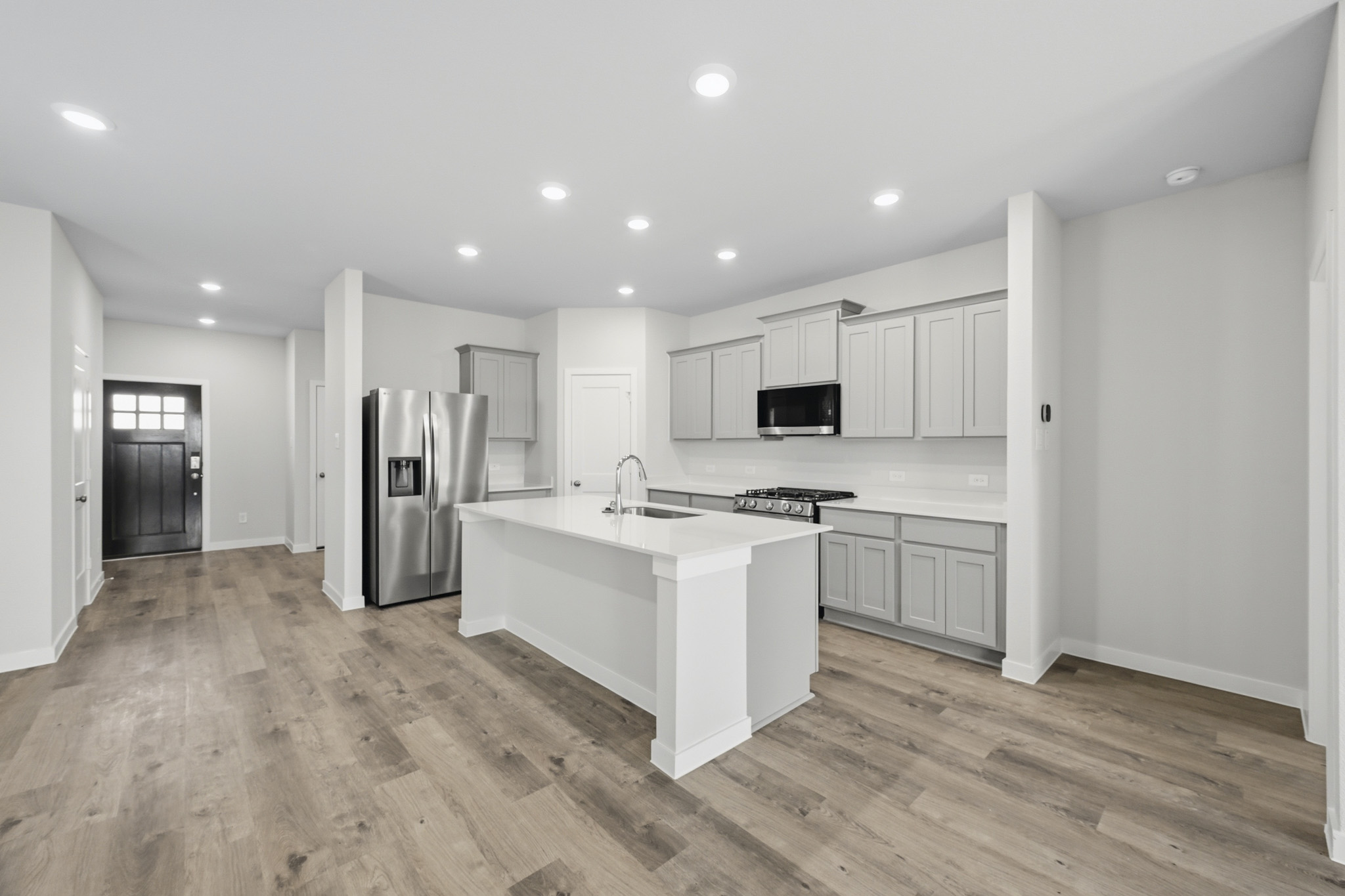 A kitchen with white cabinets.