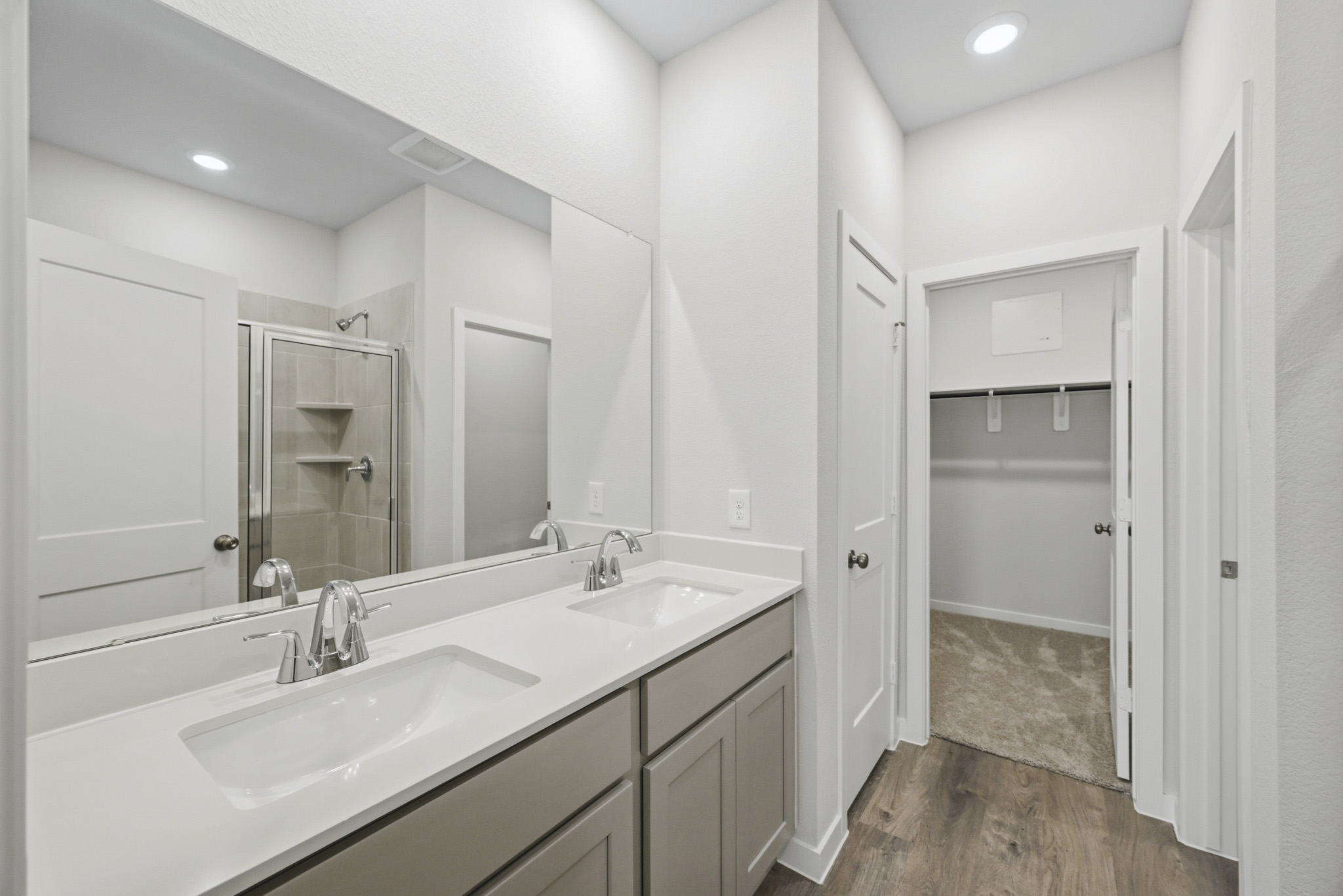 A bathroom with a large mirror.