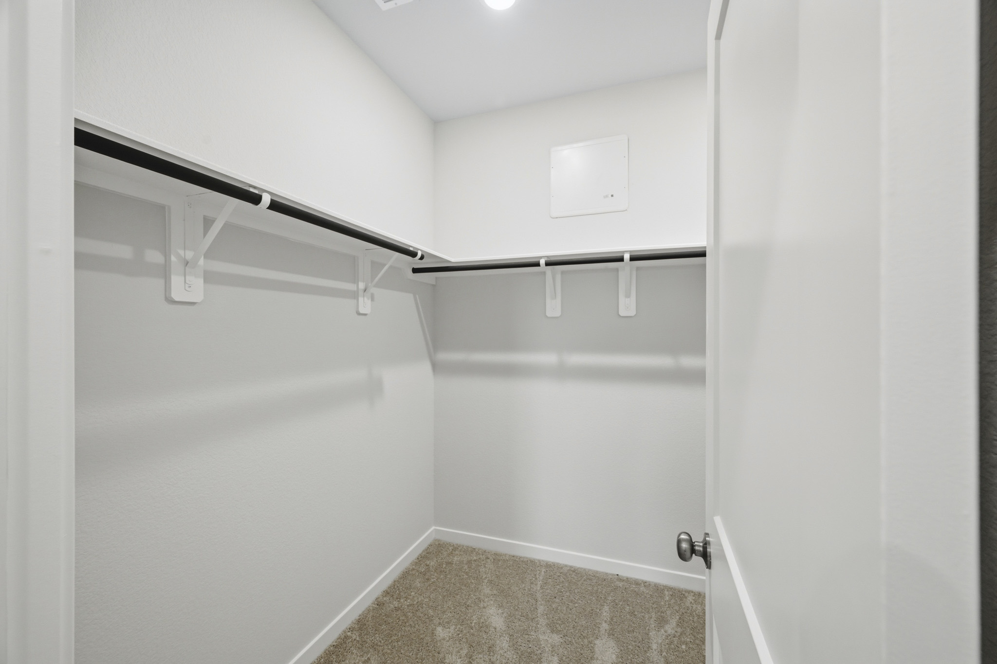 A shower with a metal bar.
