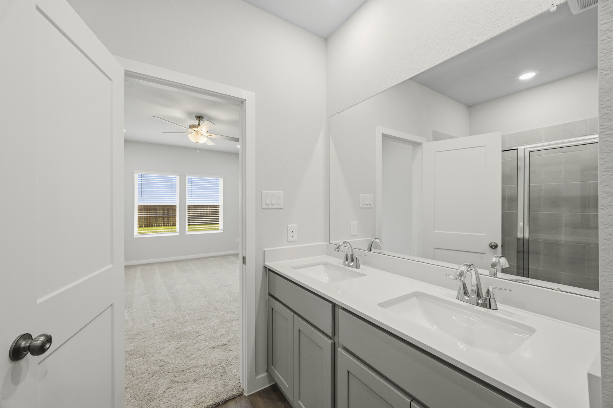 A bathroom with a large mirror.