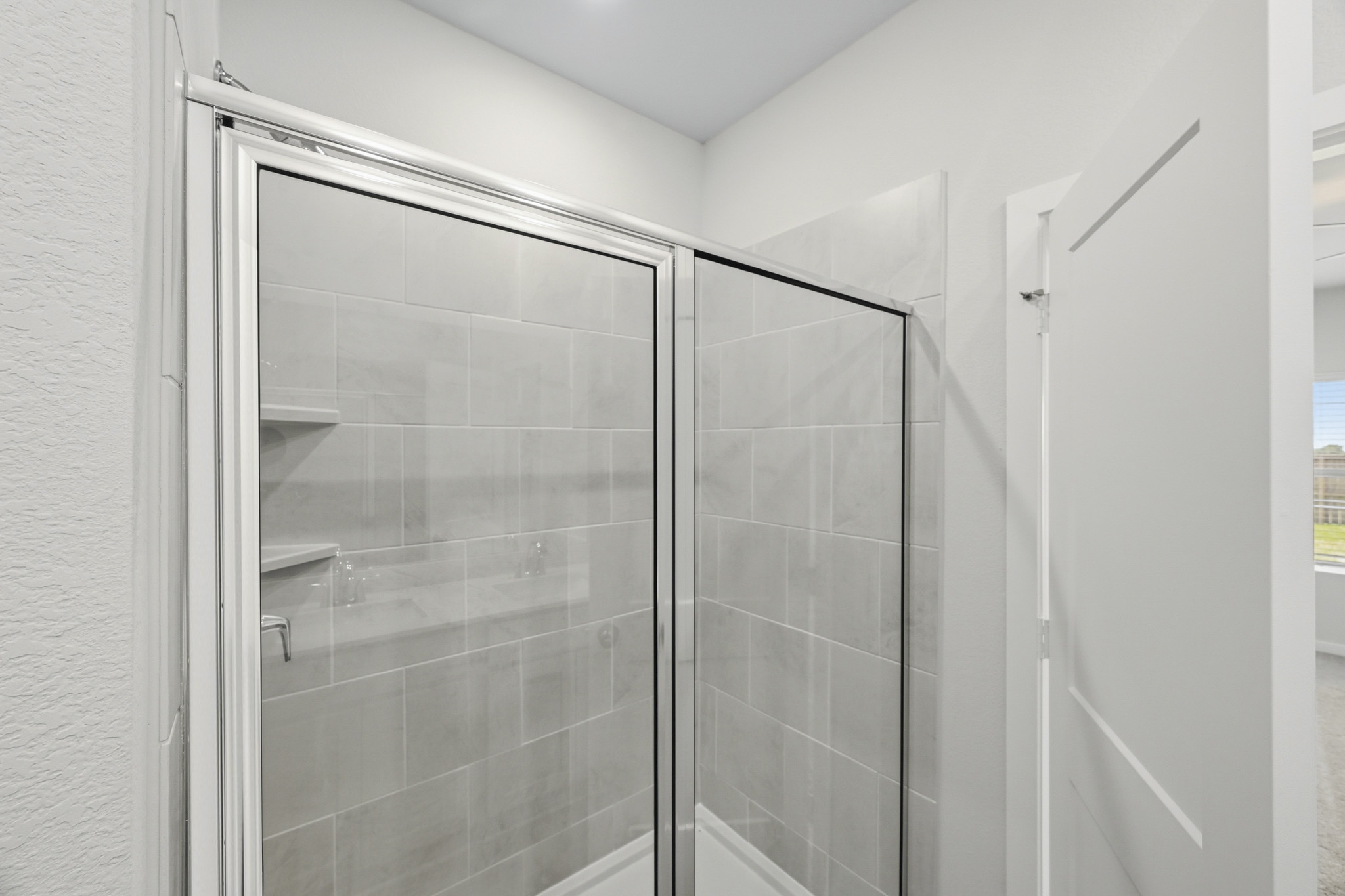 A shower with glass doors.