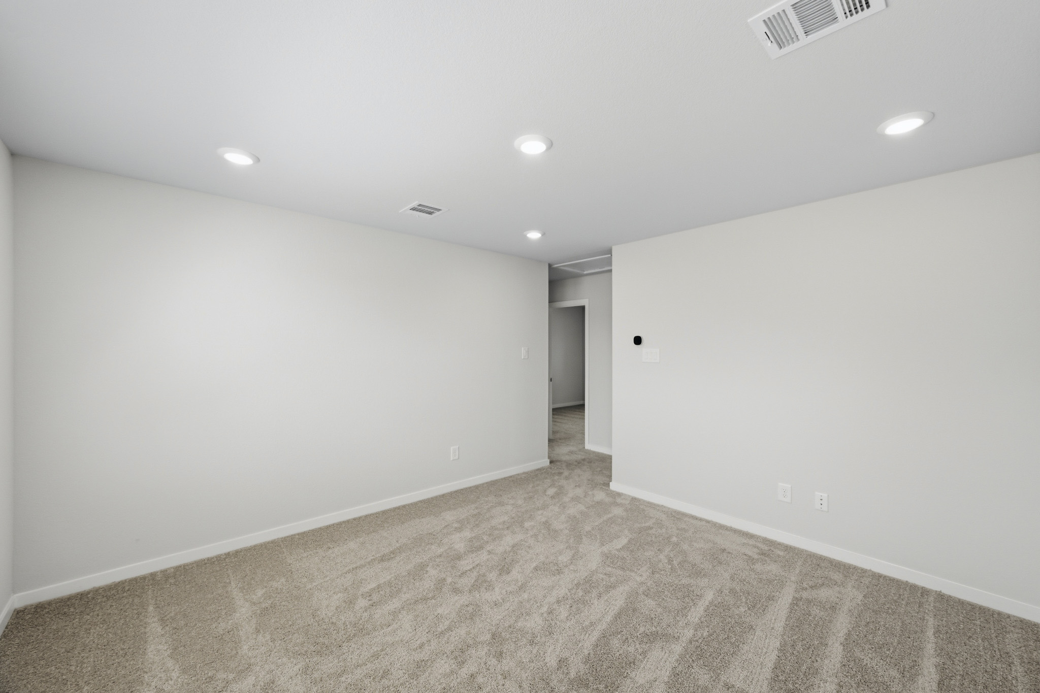 A hallway with white walls.