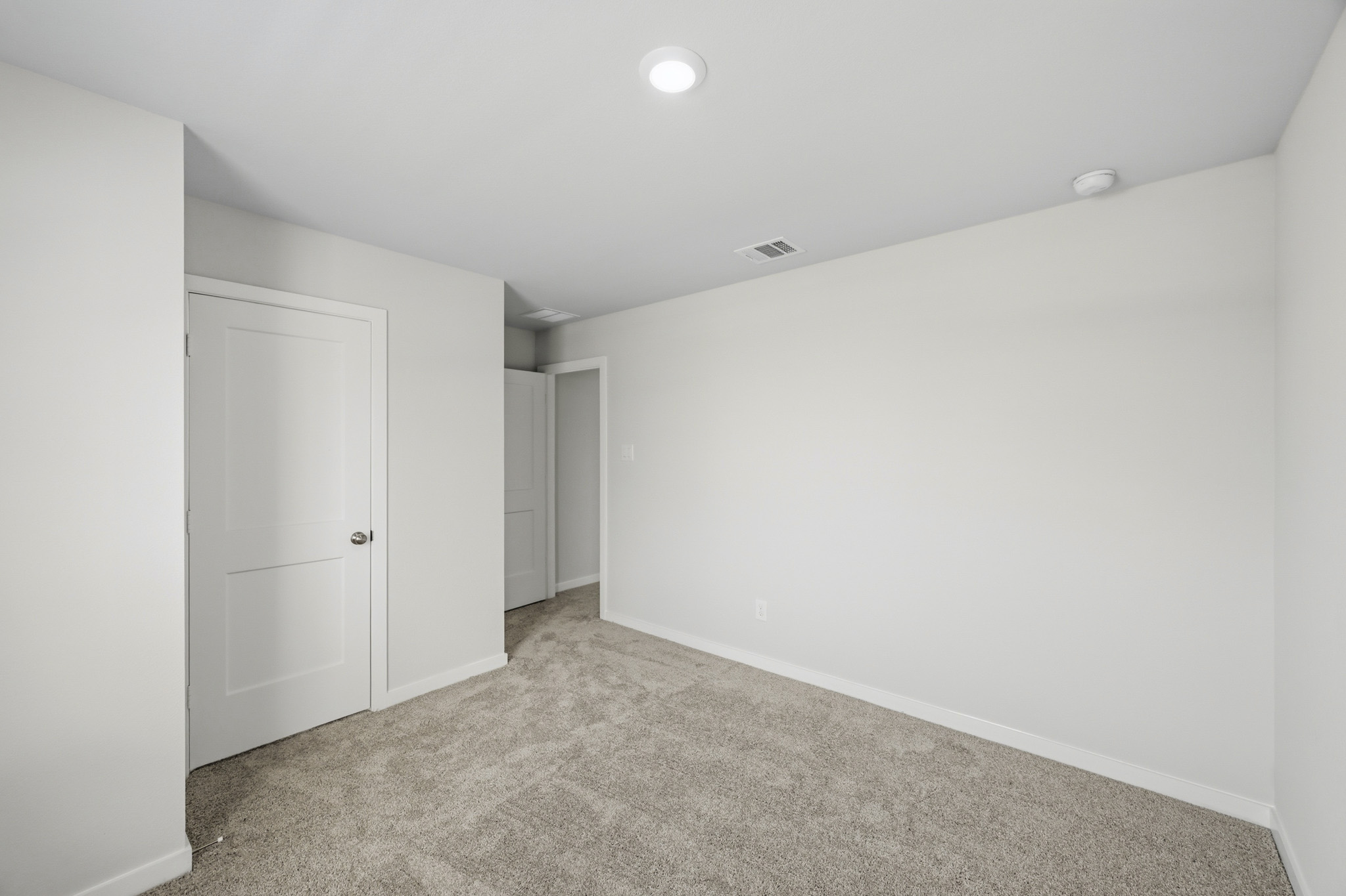 A hallway with white doors.
