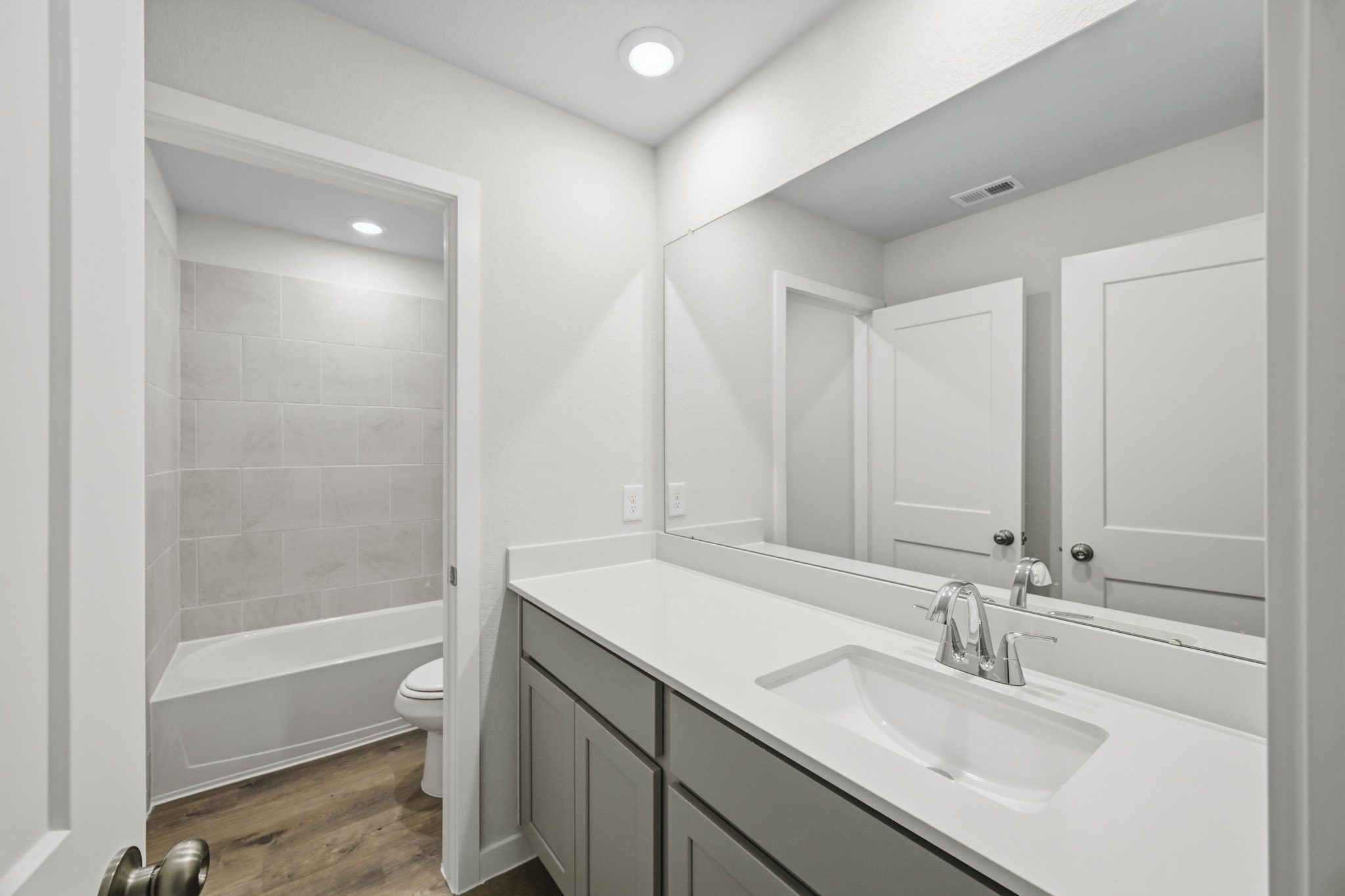A bathroom with a sink and a toilet.