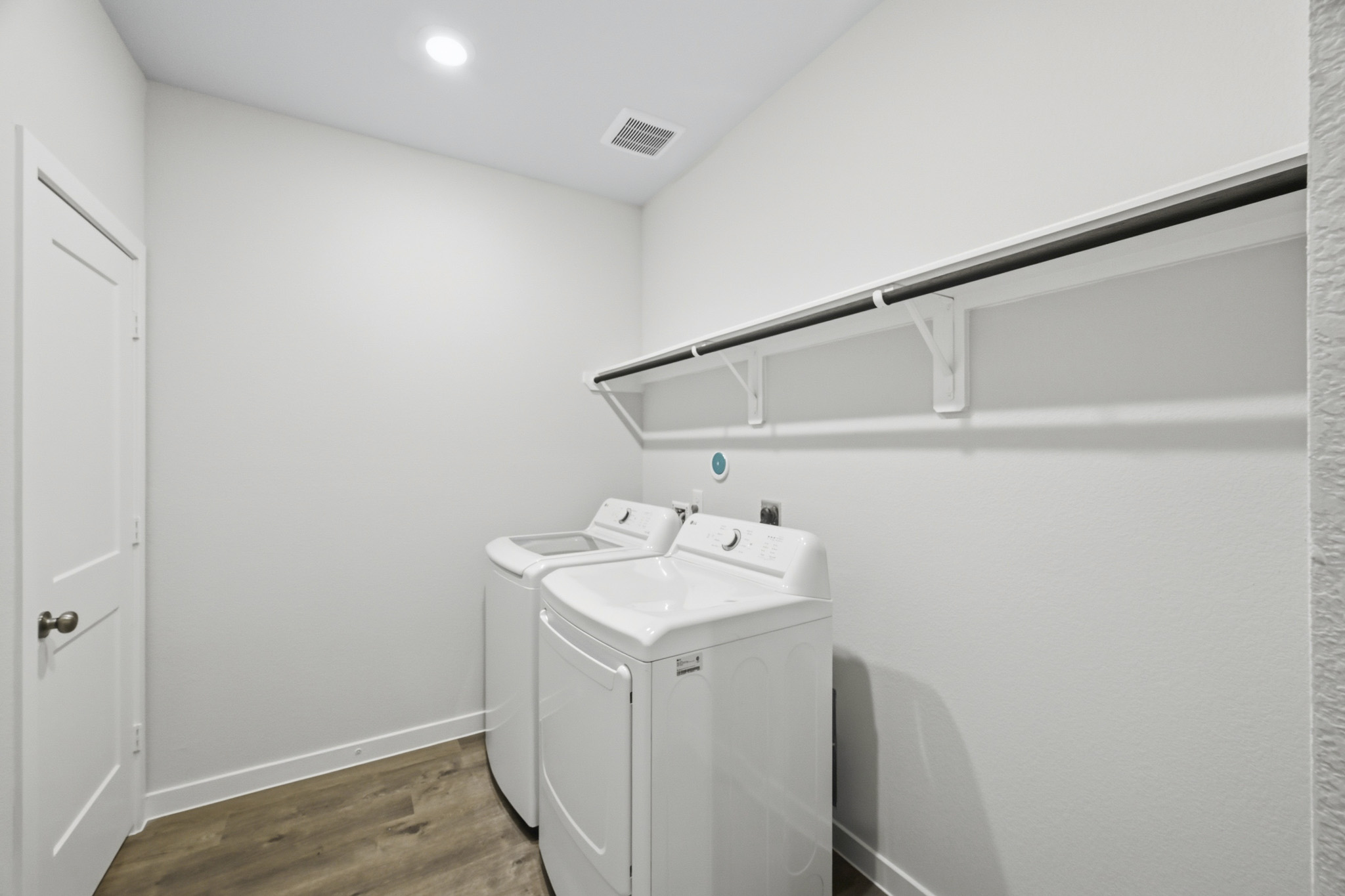 A white bathroom with a sink and a white cabinet.