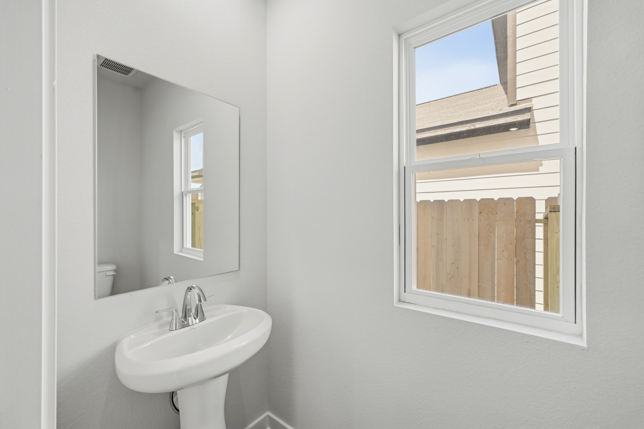 A bathroom with a sink and mirror.