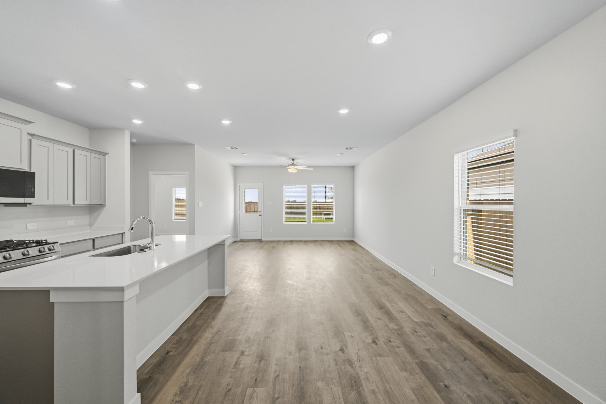 A kitchen with white cabinets.
