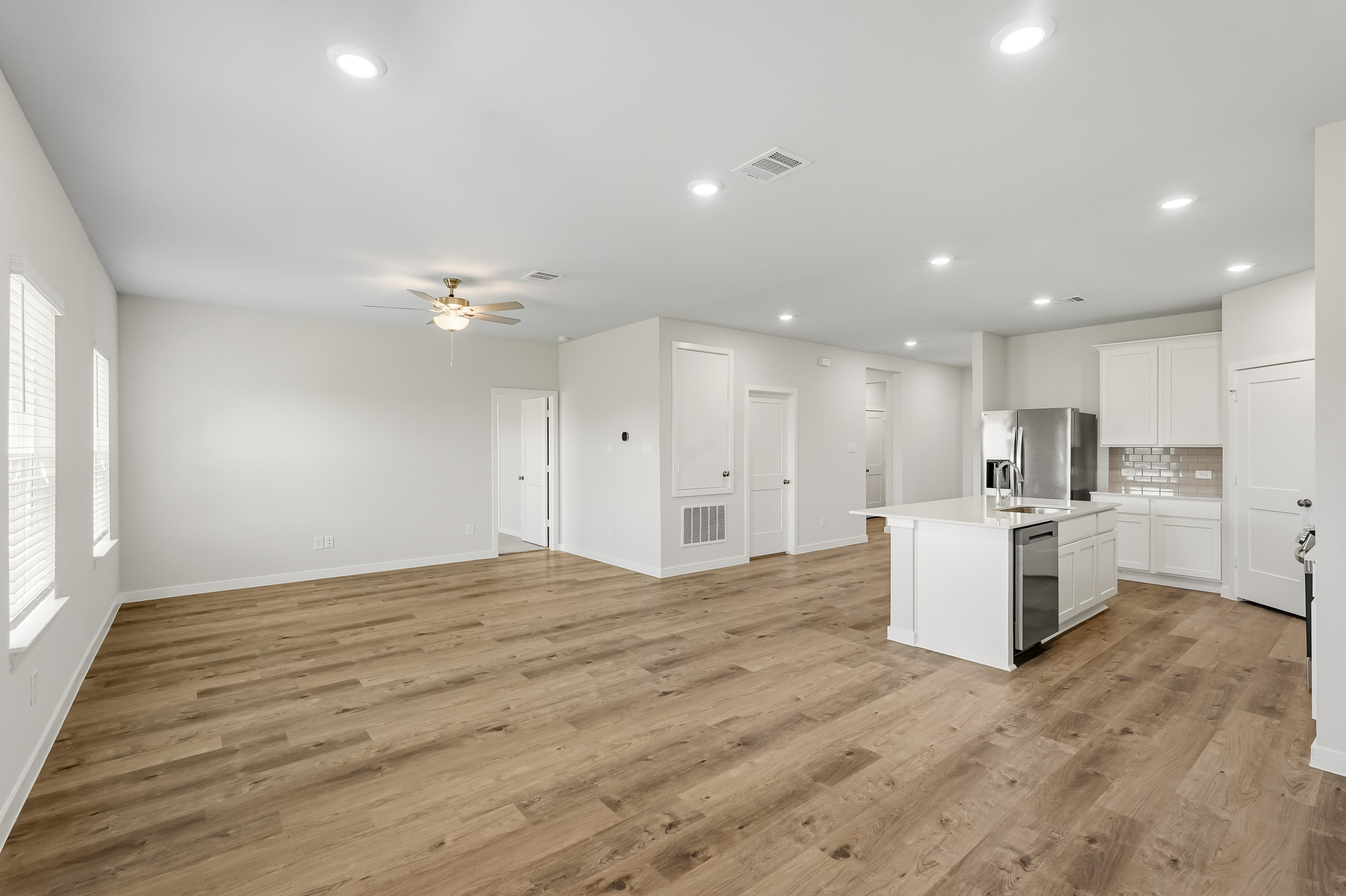 A large kitchen with white cabinets.