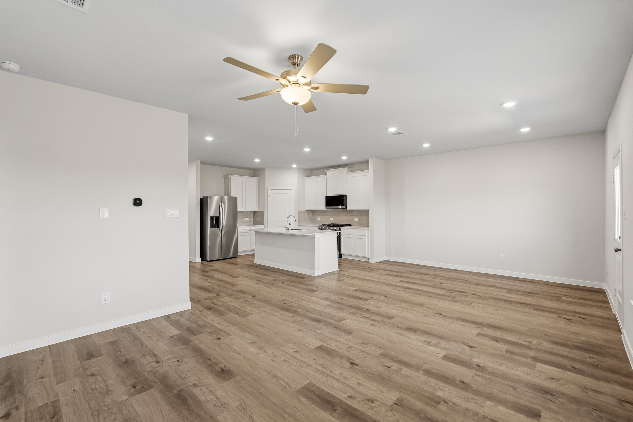 A kitchen with a wood floor.