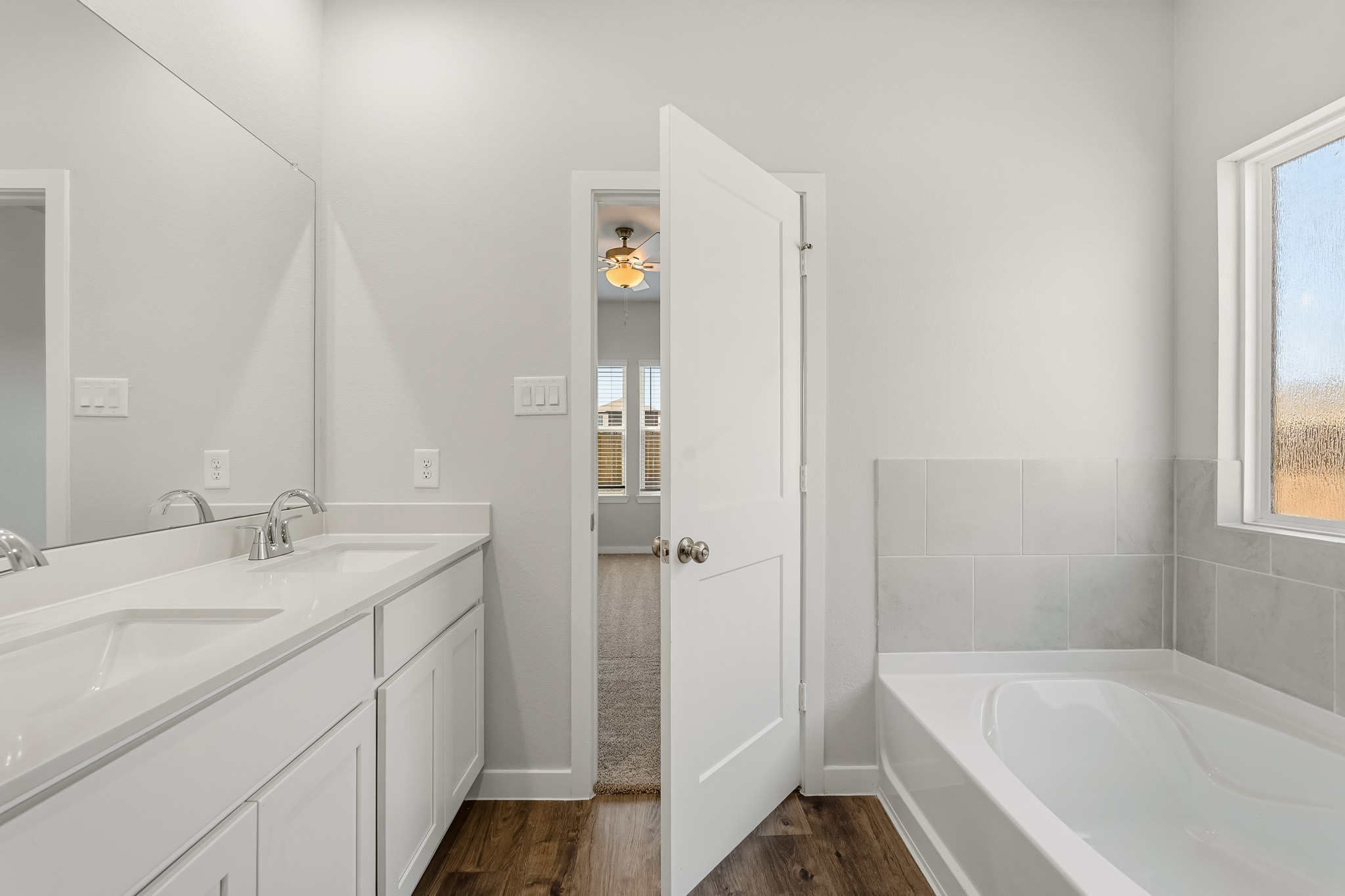 A bathroom with a tub and sink.