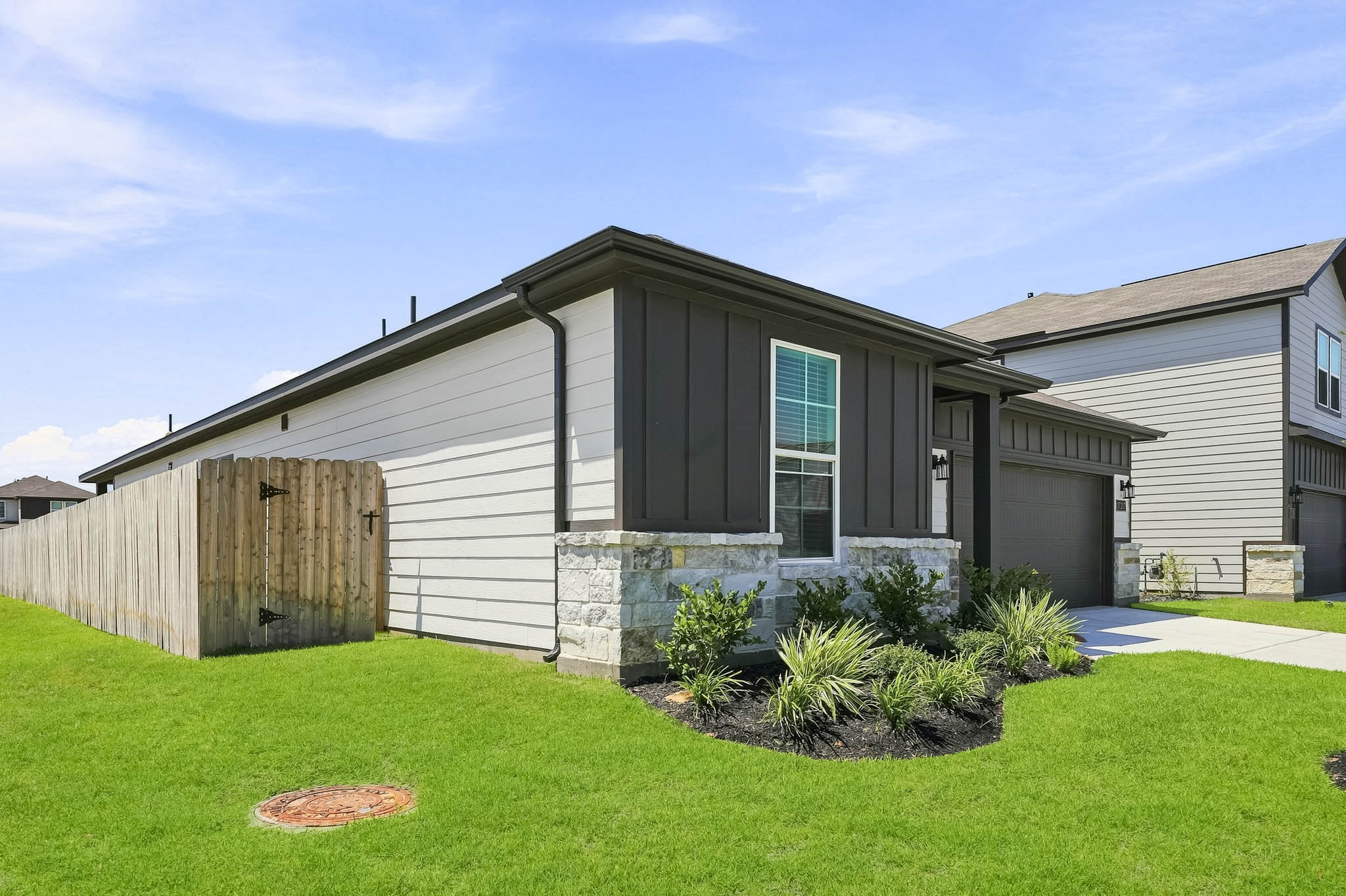 A house with a fence and grass.
