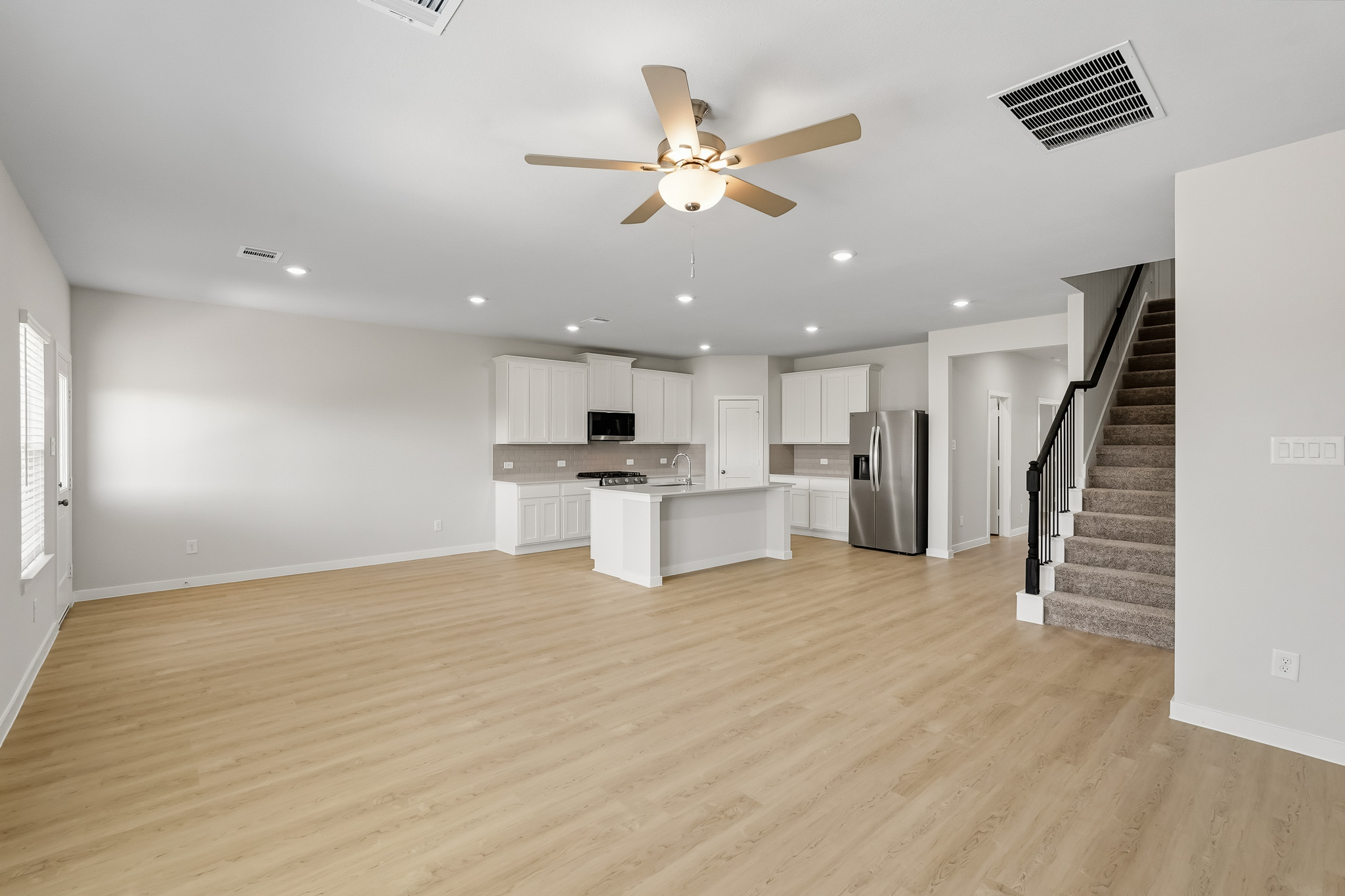 A large kitchen with a wood floor.