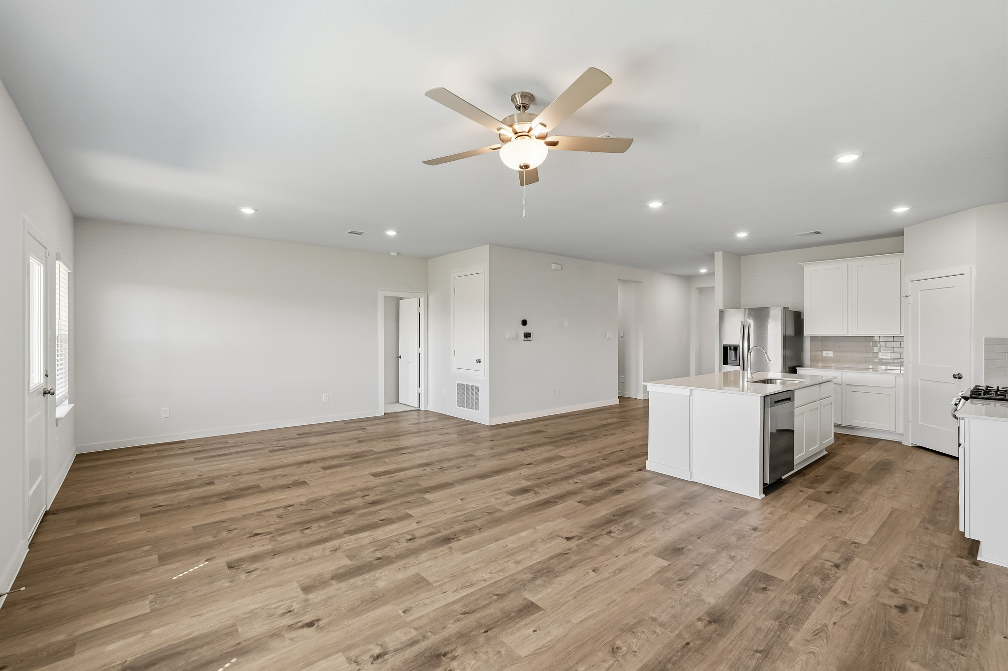 A large kitchen with white cabinets.