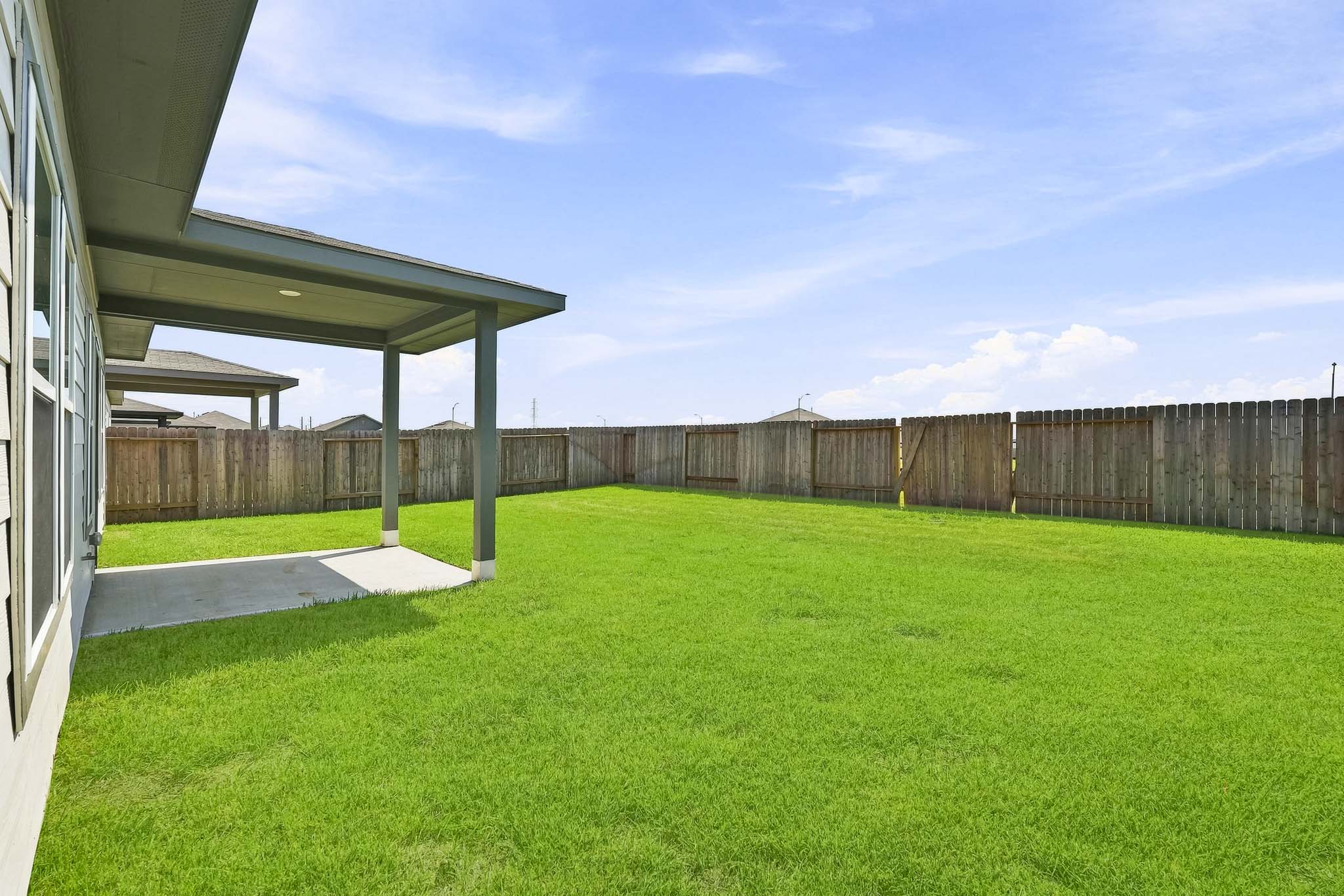 A backyard with a fence.