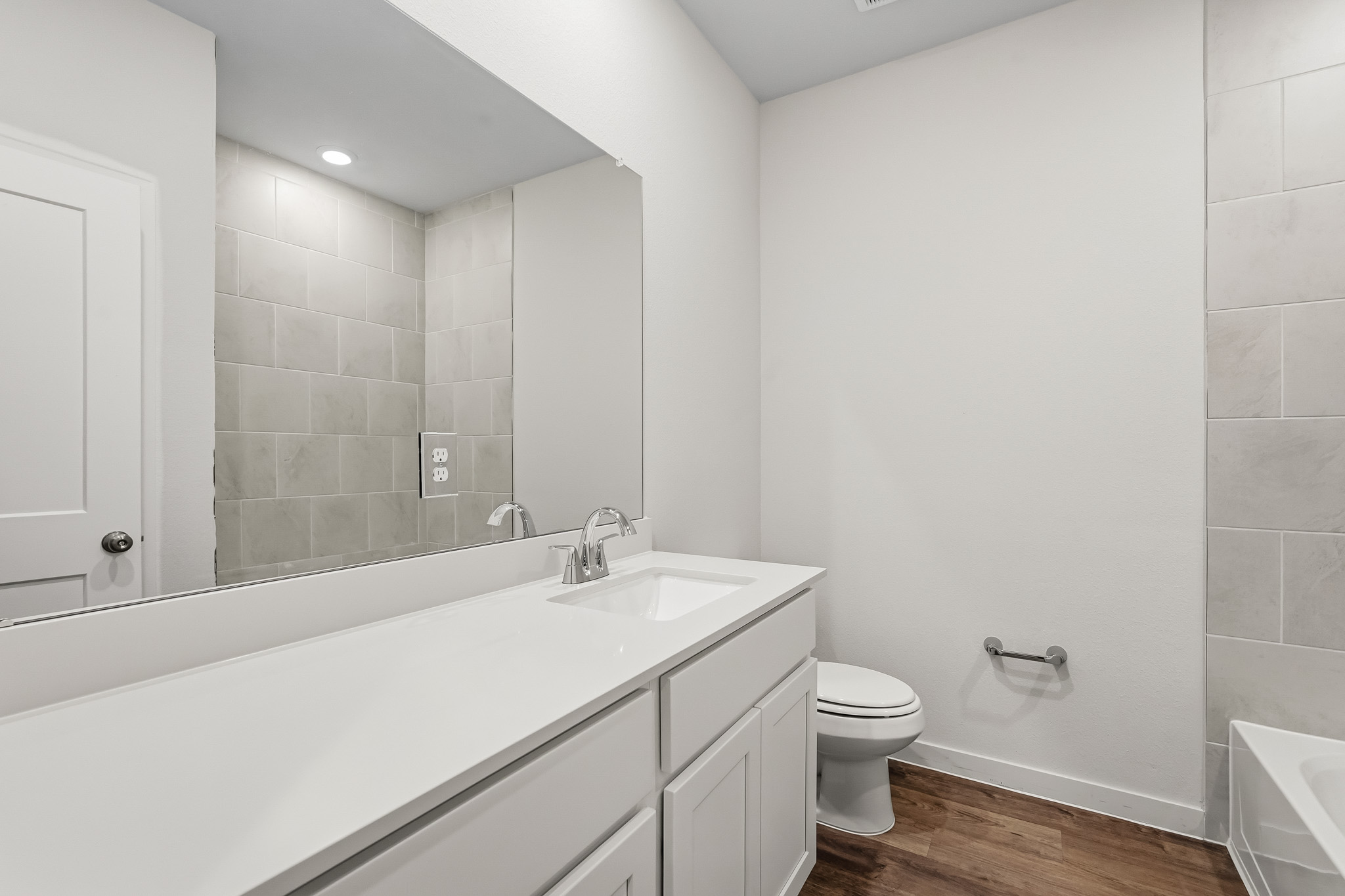 A bathroom with a tub sink and toilet.