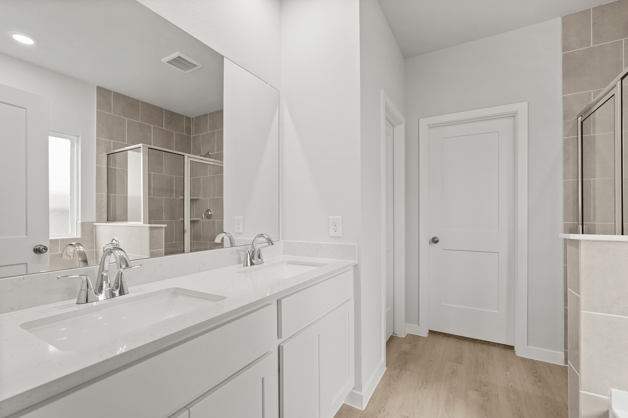 A bathroom with a large mirror.