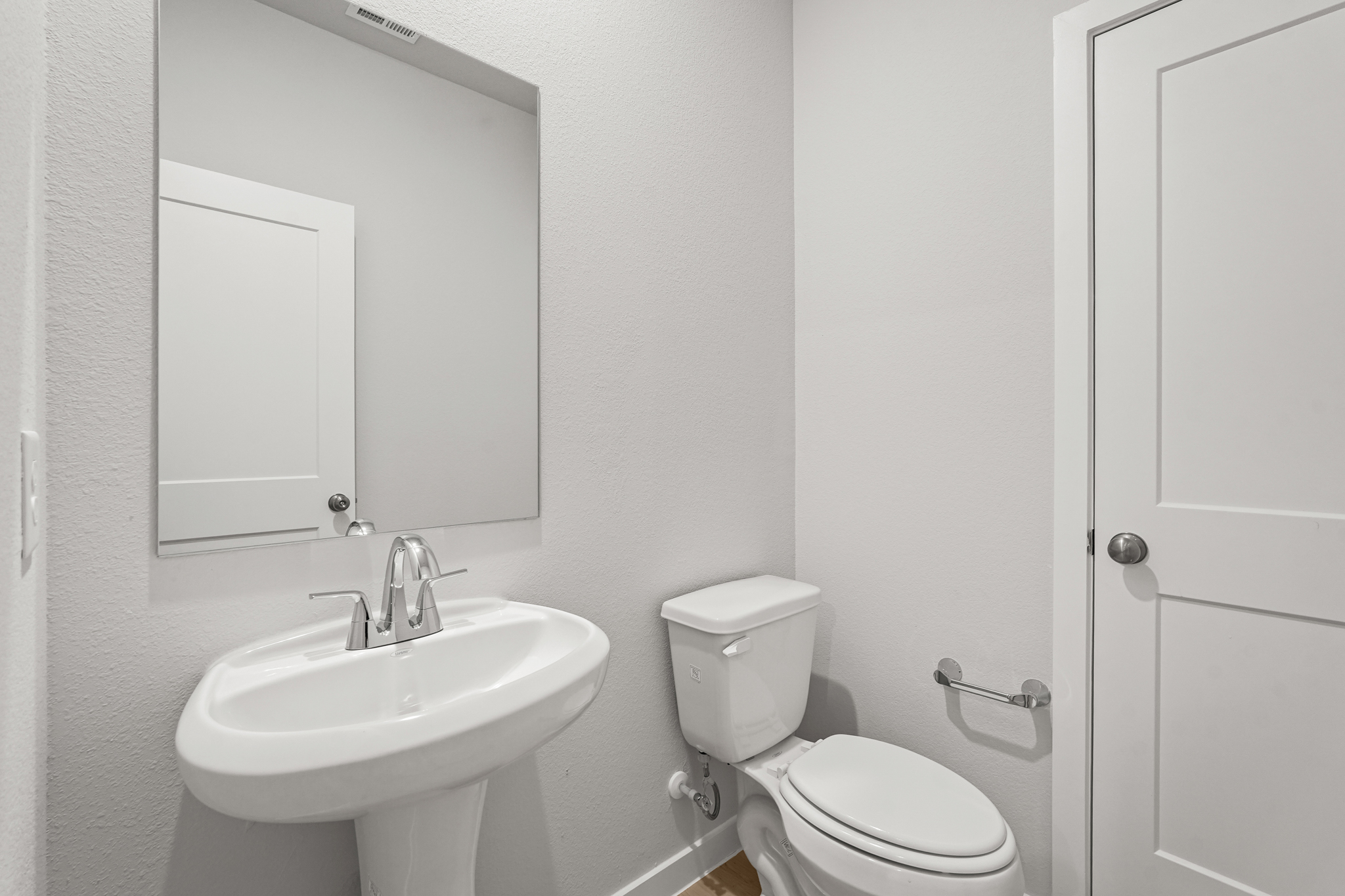 A bathroom with a toilet and sink.