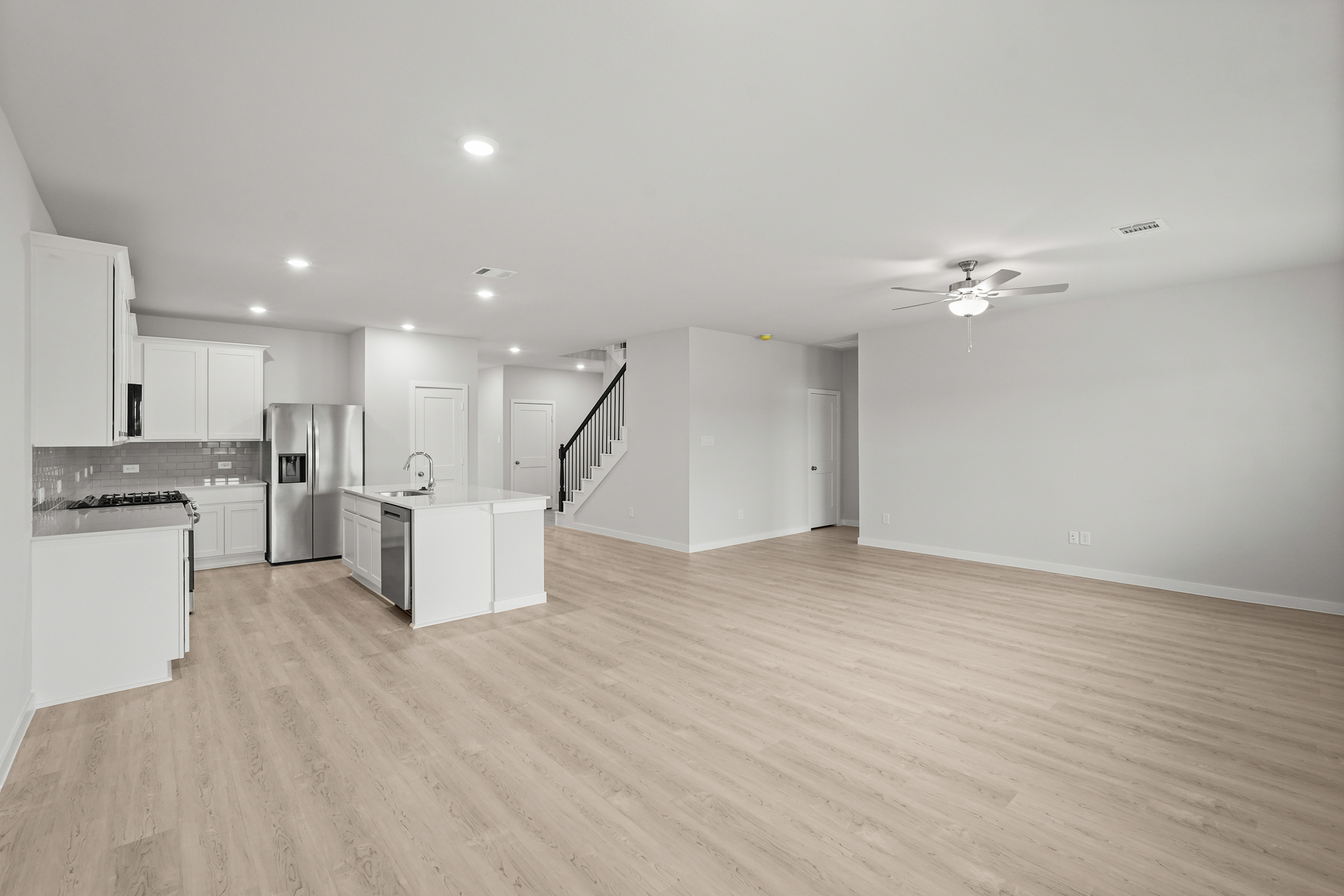 A large kitchen with white cabinets.