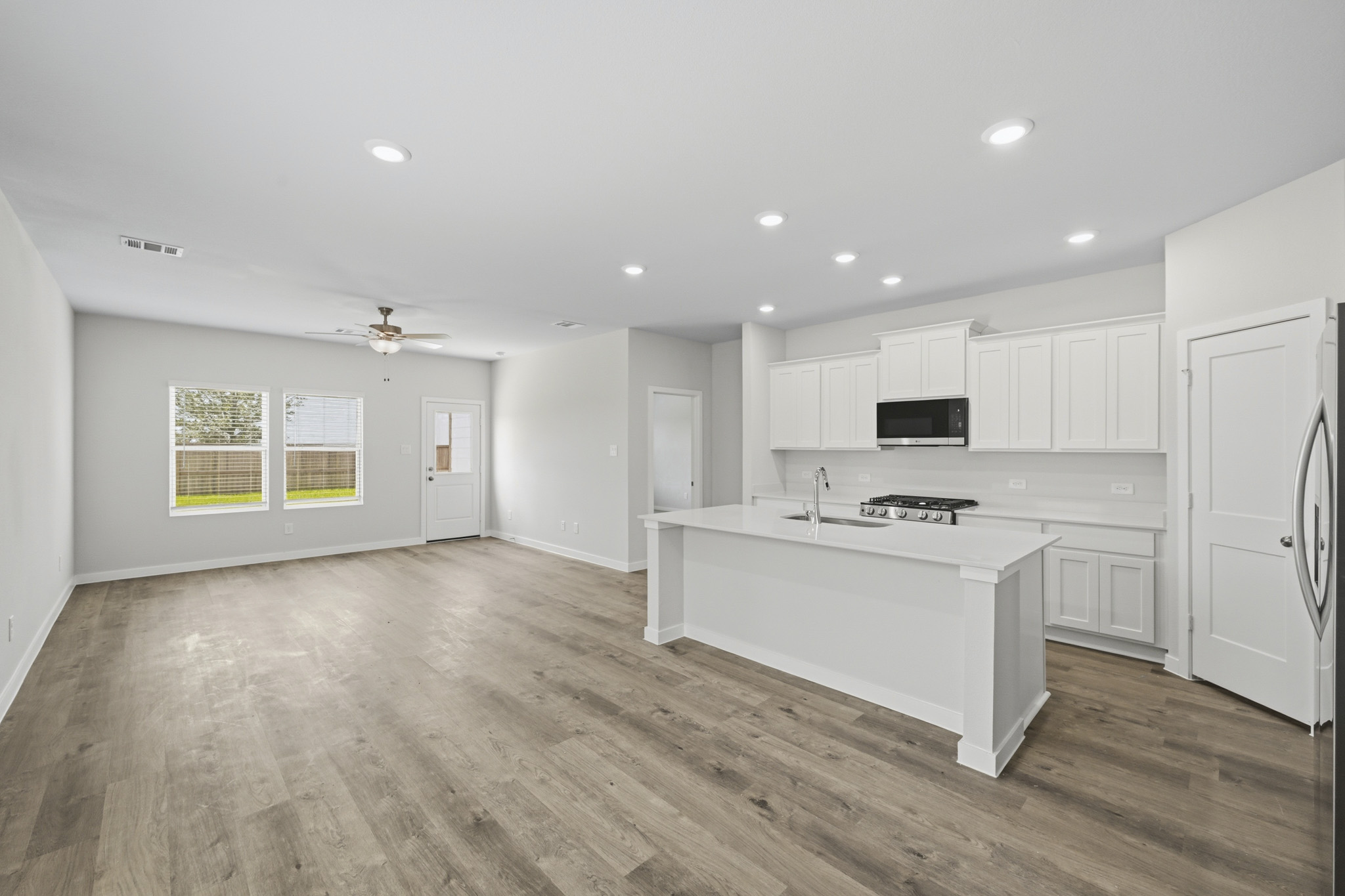 A kitchen with white cabinets.