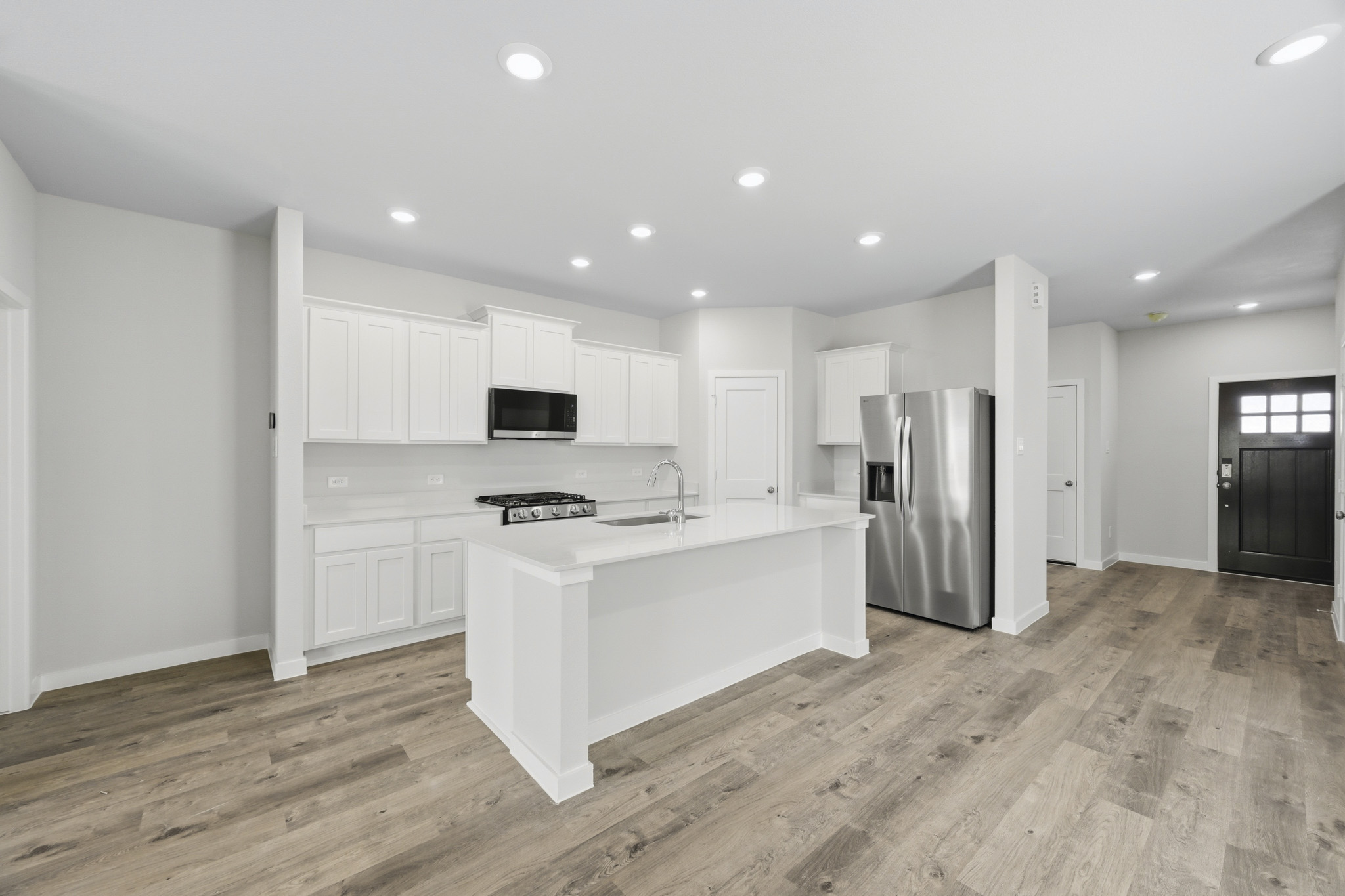 A kitchen with white cabinets.