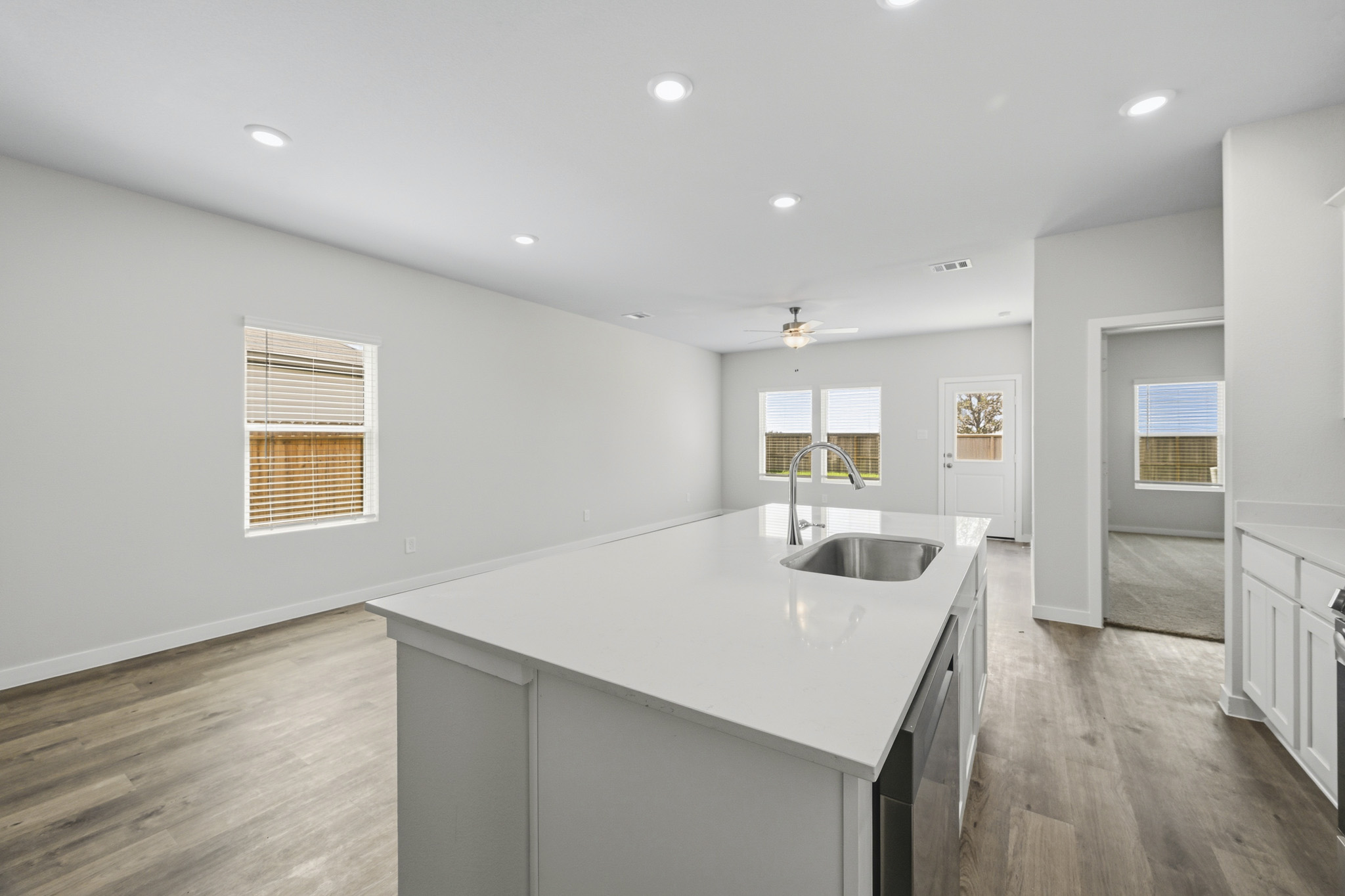 A kitchen with white cabinets.