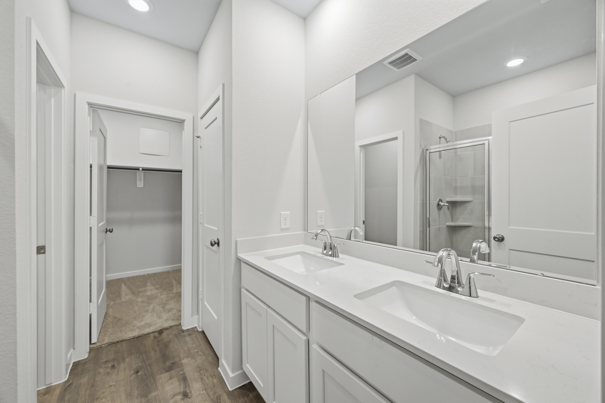 A bathroom with a large mirror.