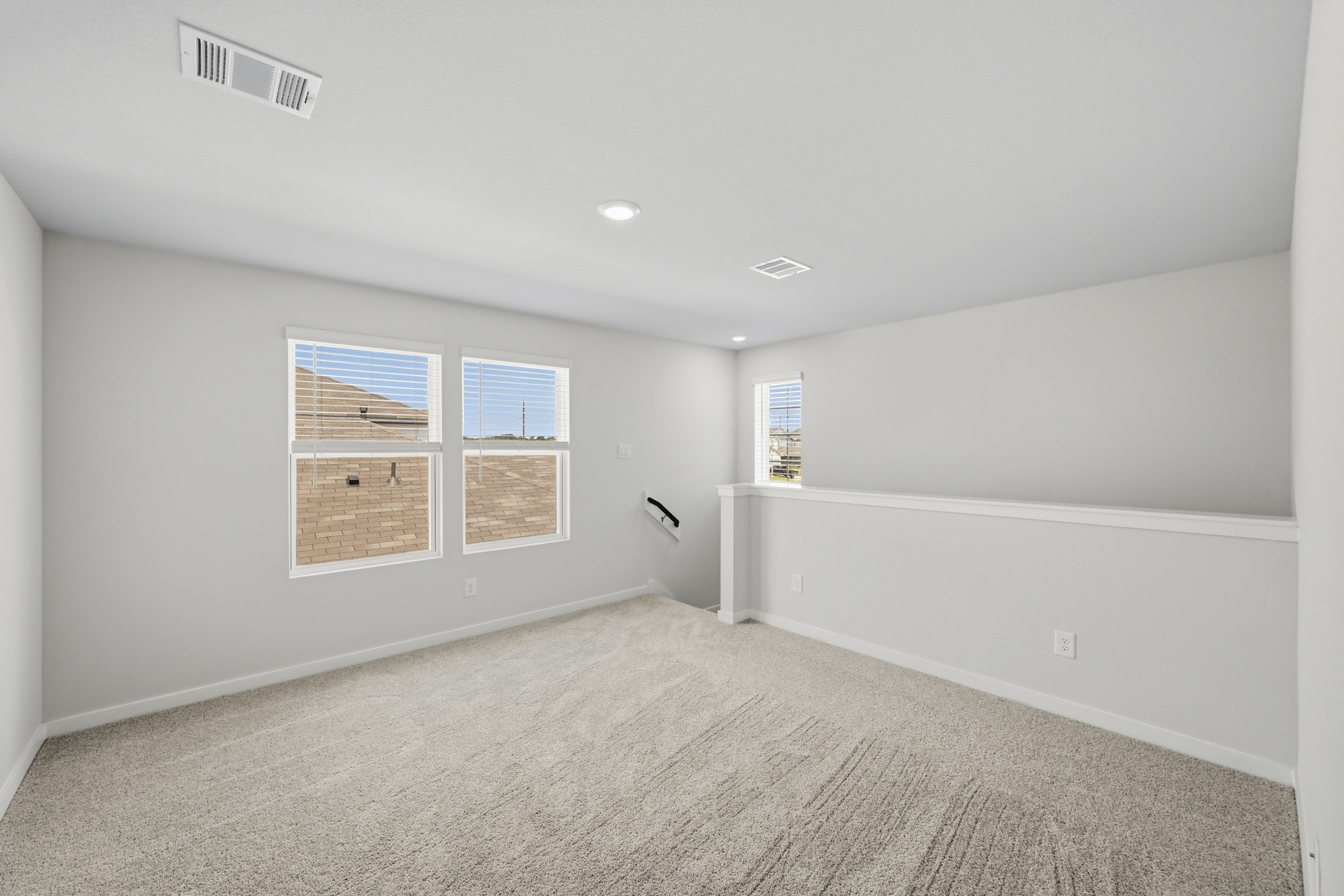 A room with a carpet and a window.