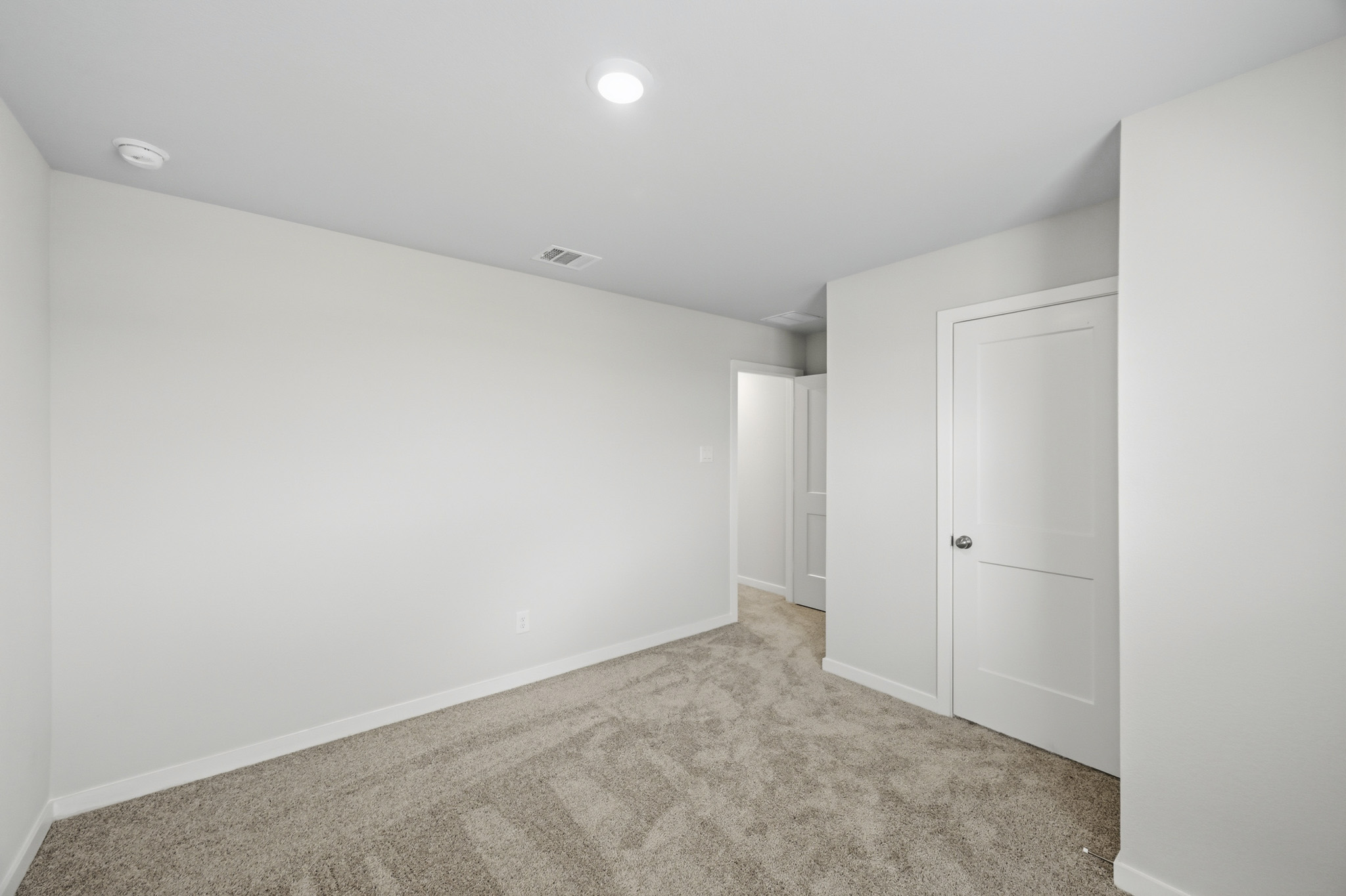 A hallway with white doors.
