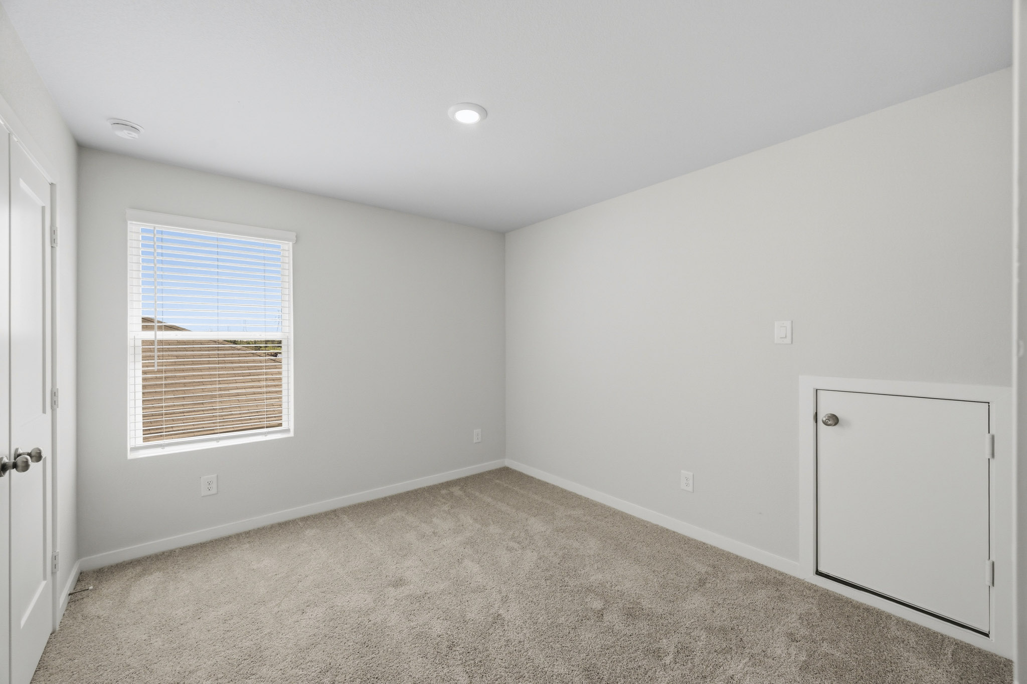 A room with a window and a door.