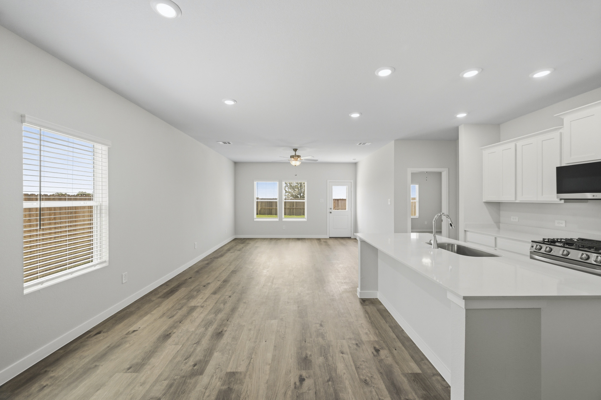 A kitchen with white cabinets.