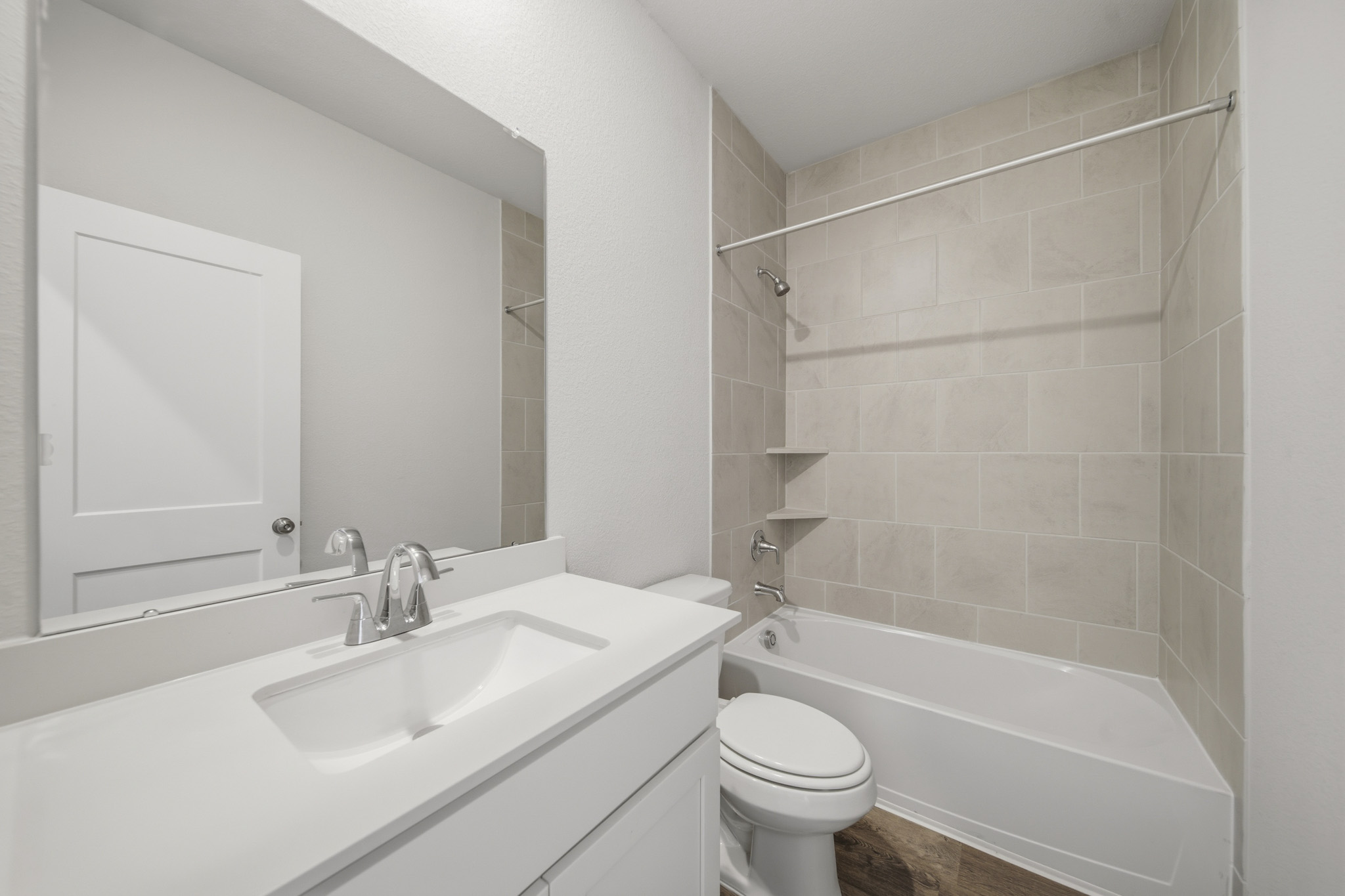 A bathroom with a tub sink and toilet.