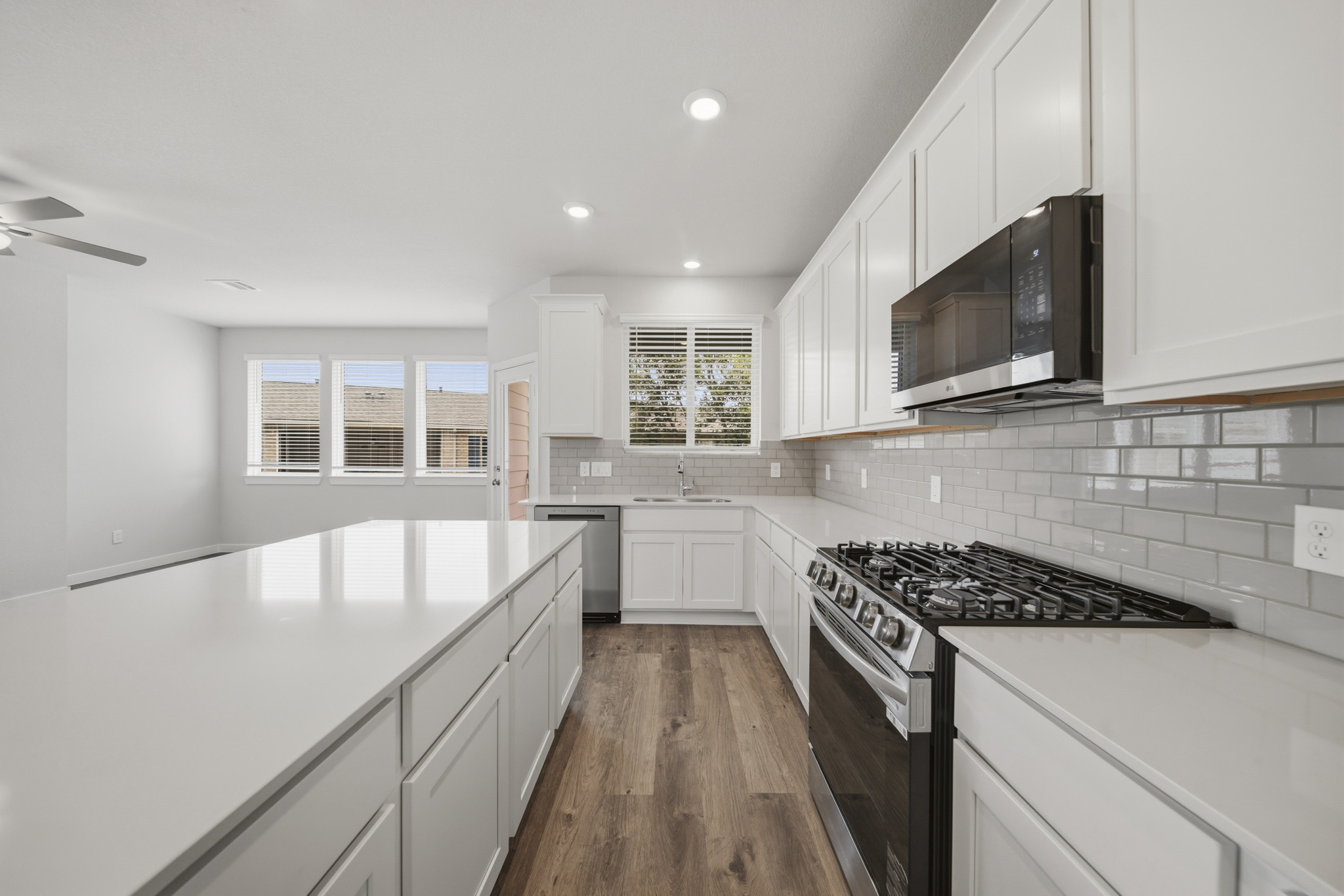 A kitchen with white cabinets.