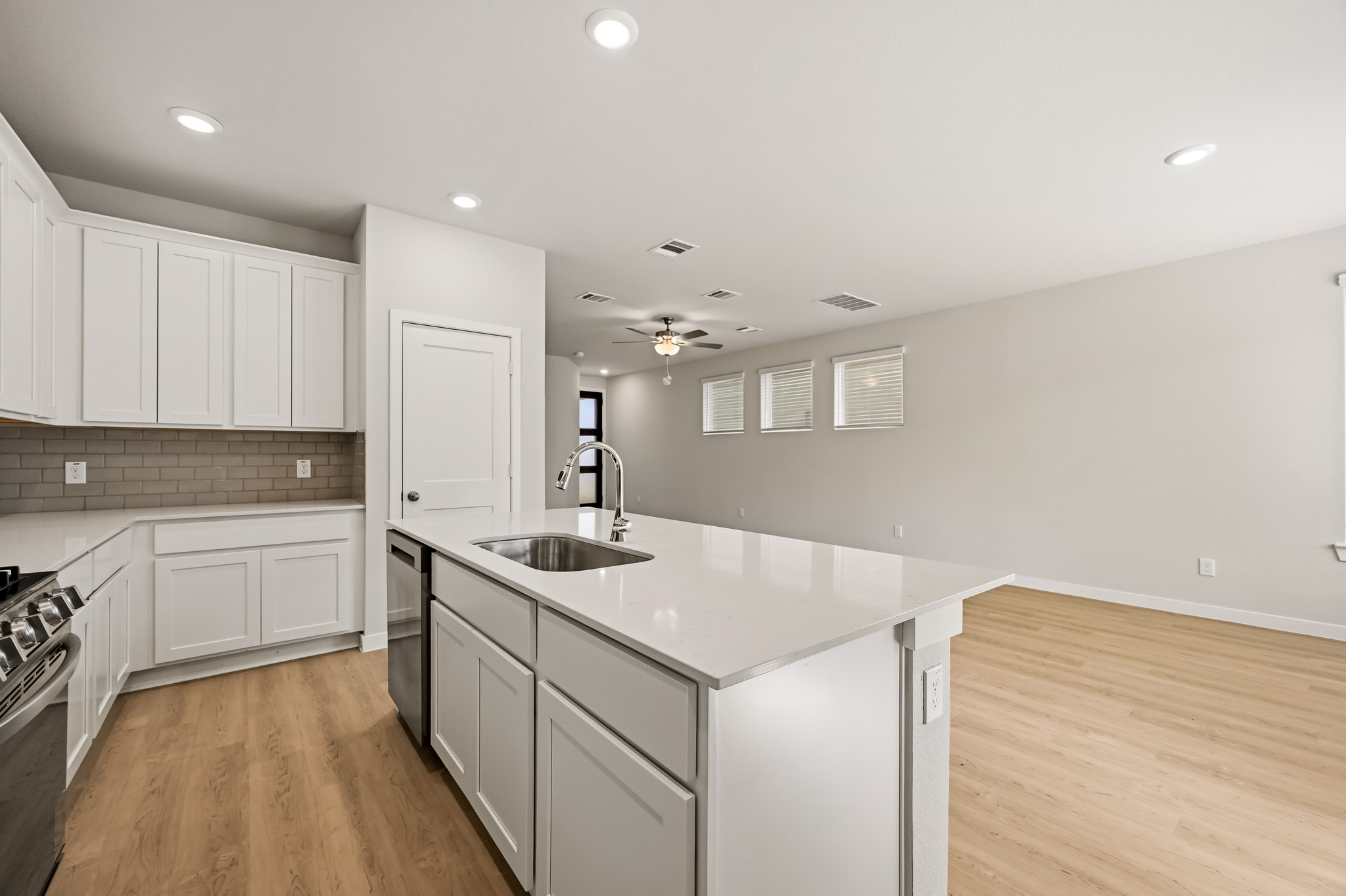 A kitchen with white cabinets.