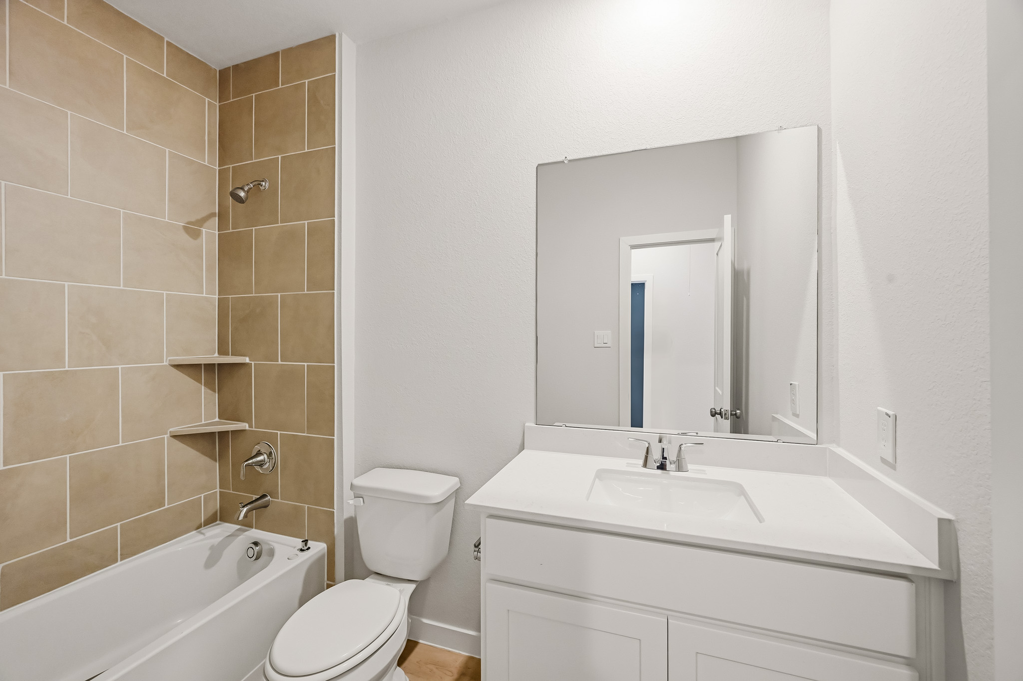 A bathroom with a tub sink and toilet.