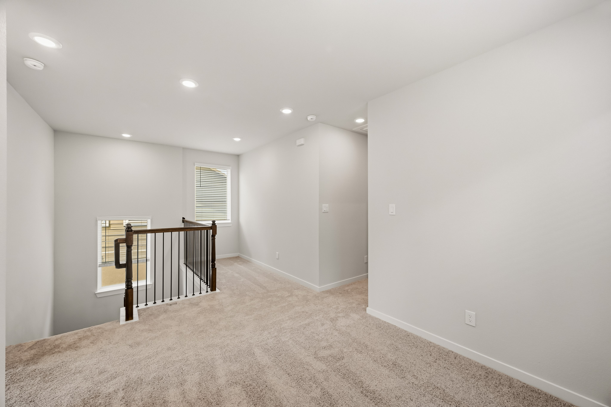 A room with a carpet and a railing.