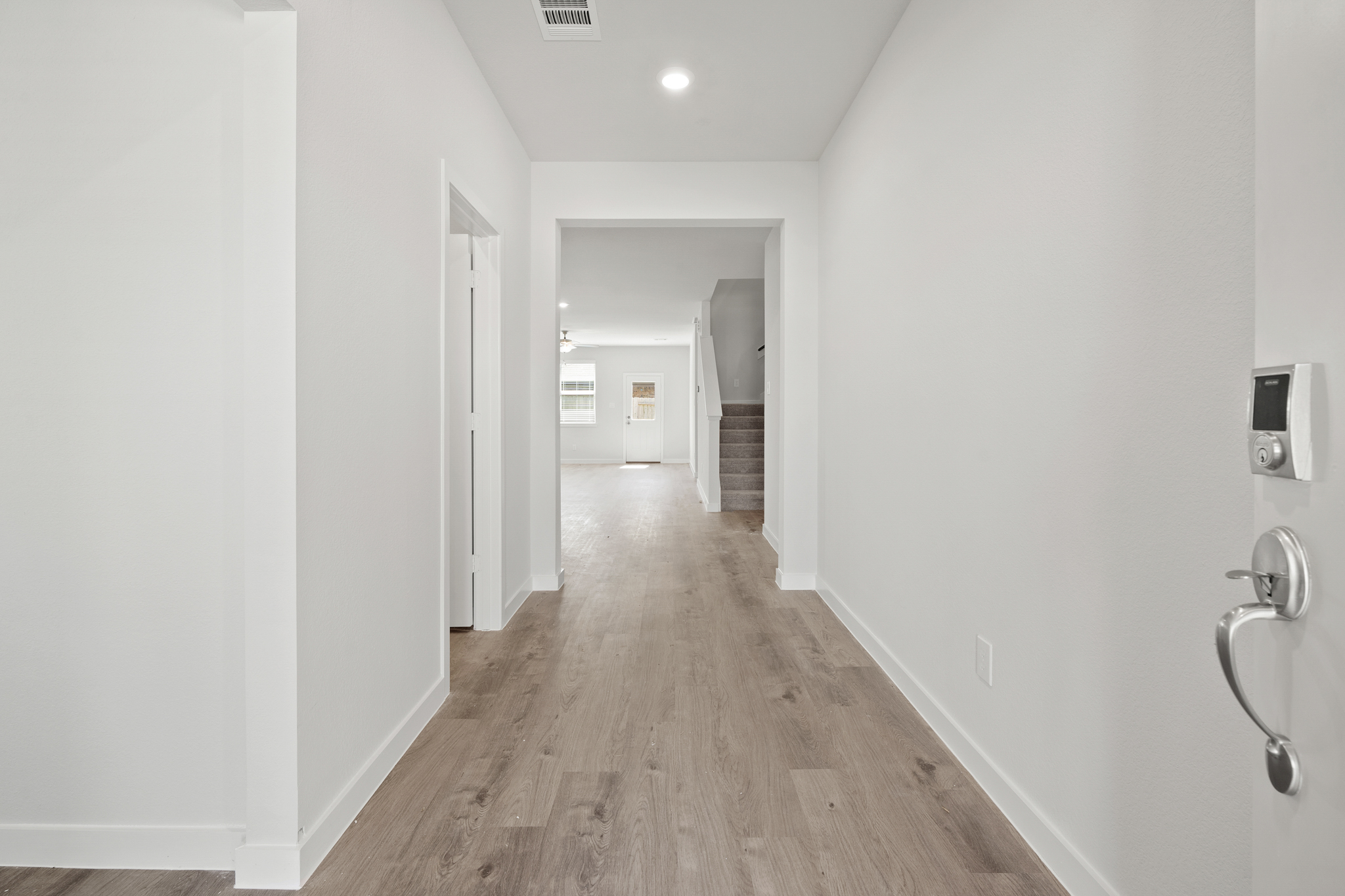 A hallway with white walls.
