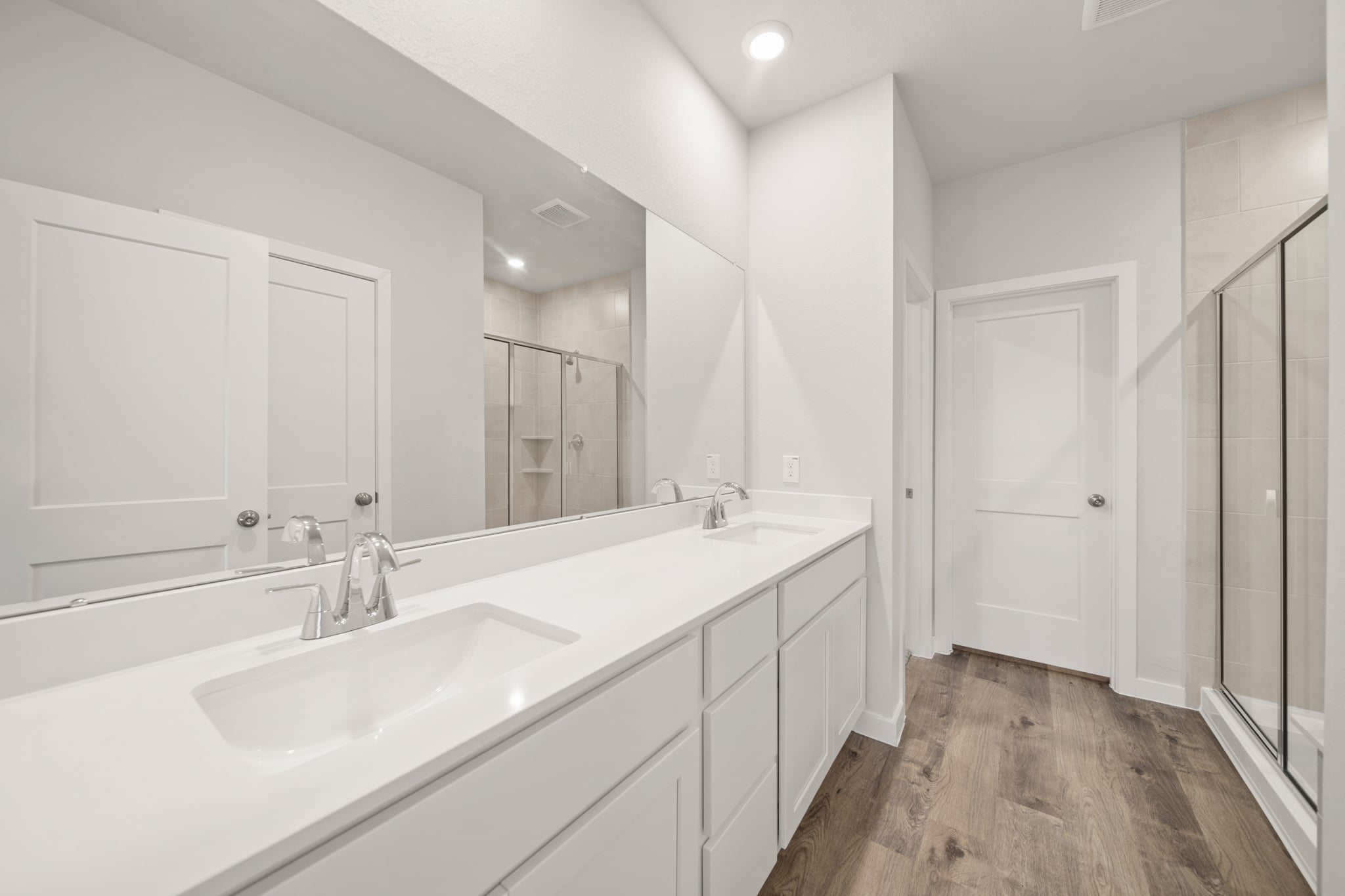 A bathroom with white cabinets.