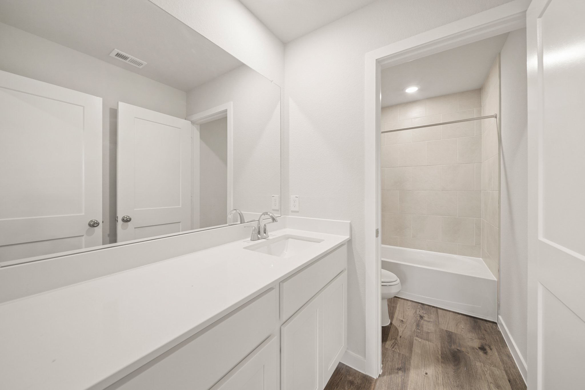 A bathroom with a tub sink and toilet.