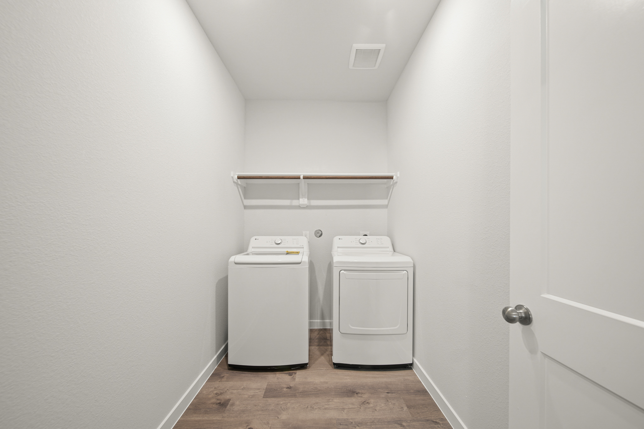 A room with a washer and dryer.