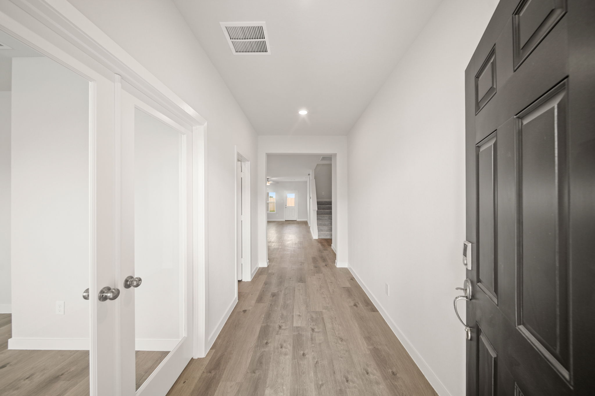 A hallway with white doors.