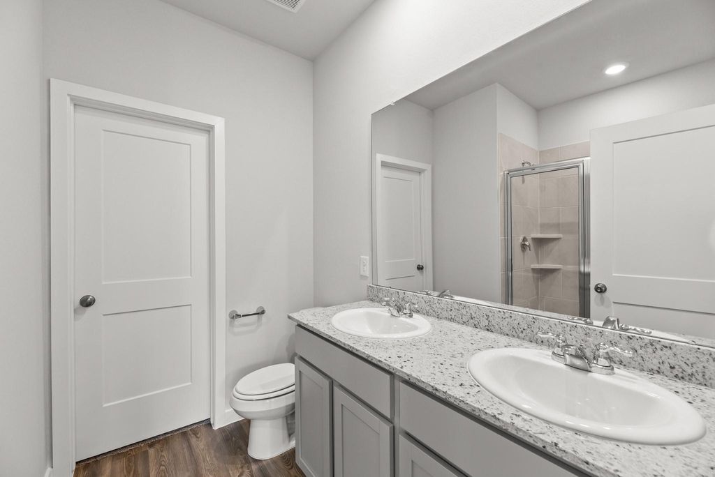 A bathroom with a large mirror.