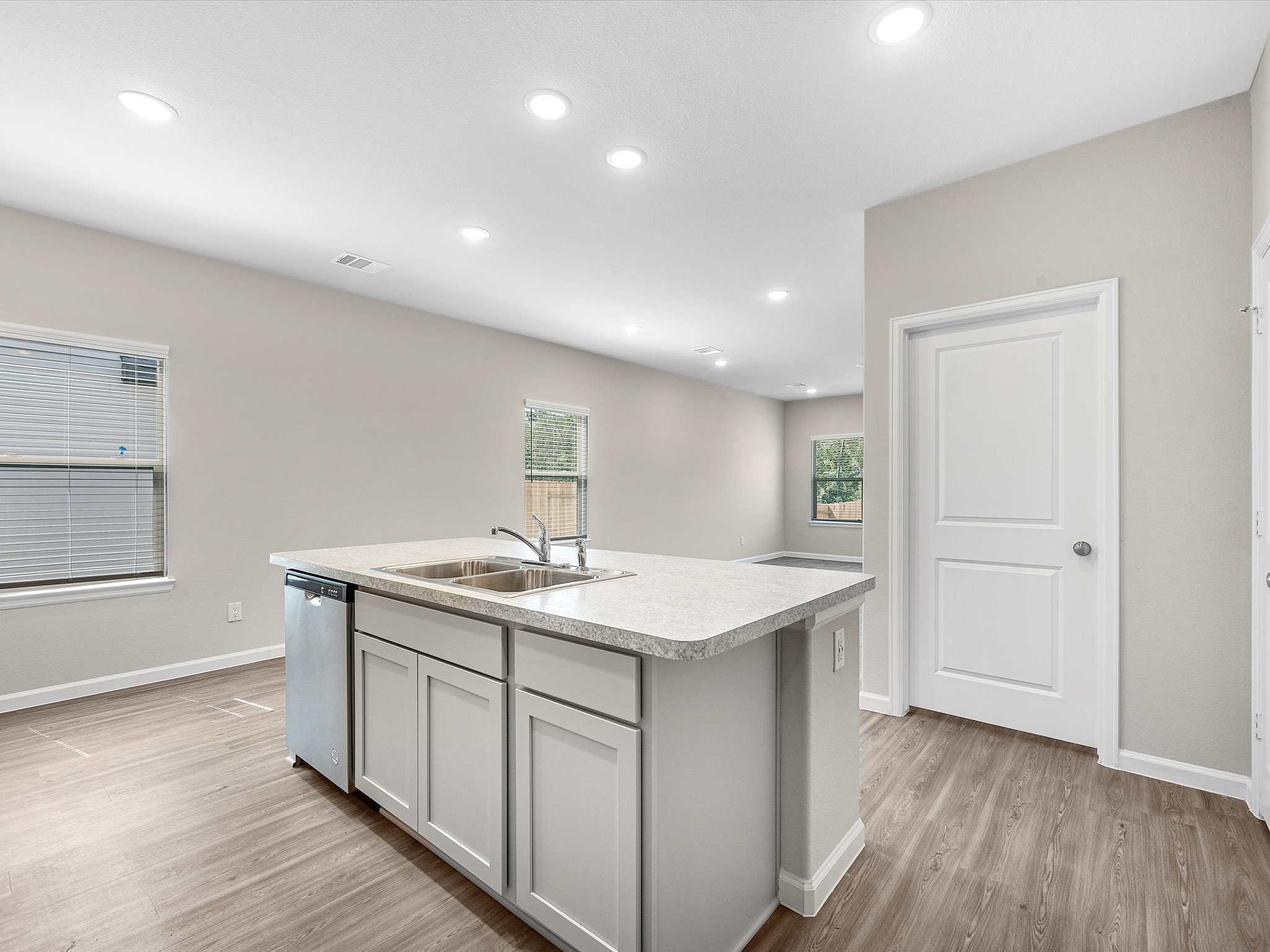 A kitchen with white cabinets.