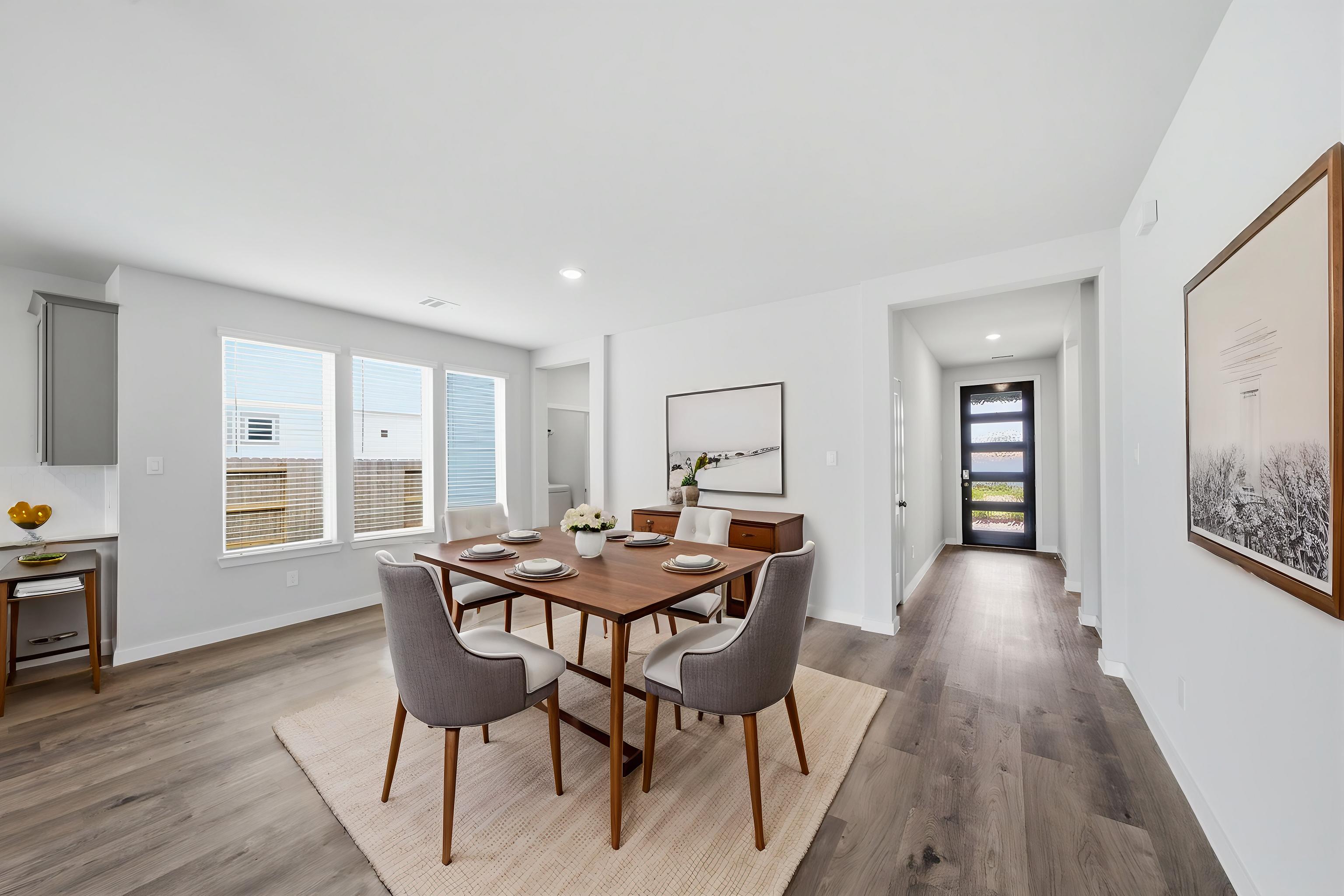A dining room with a wood floor.