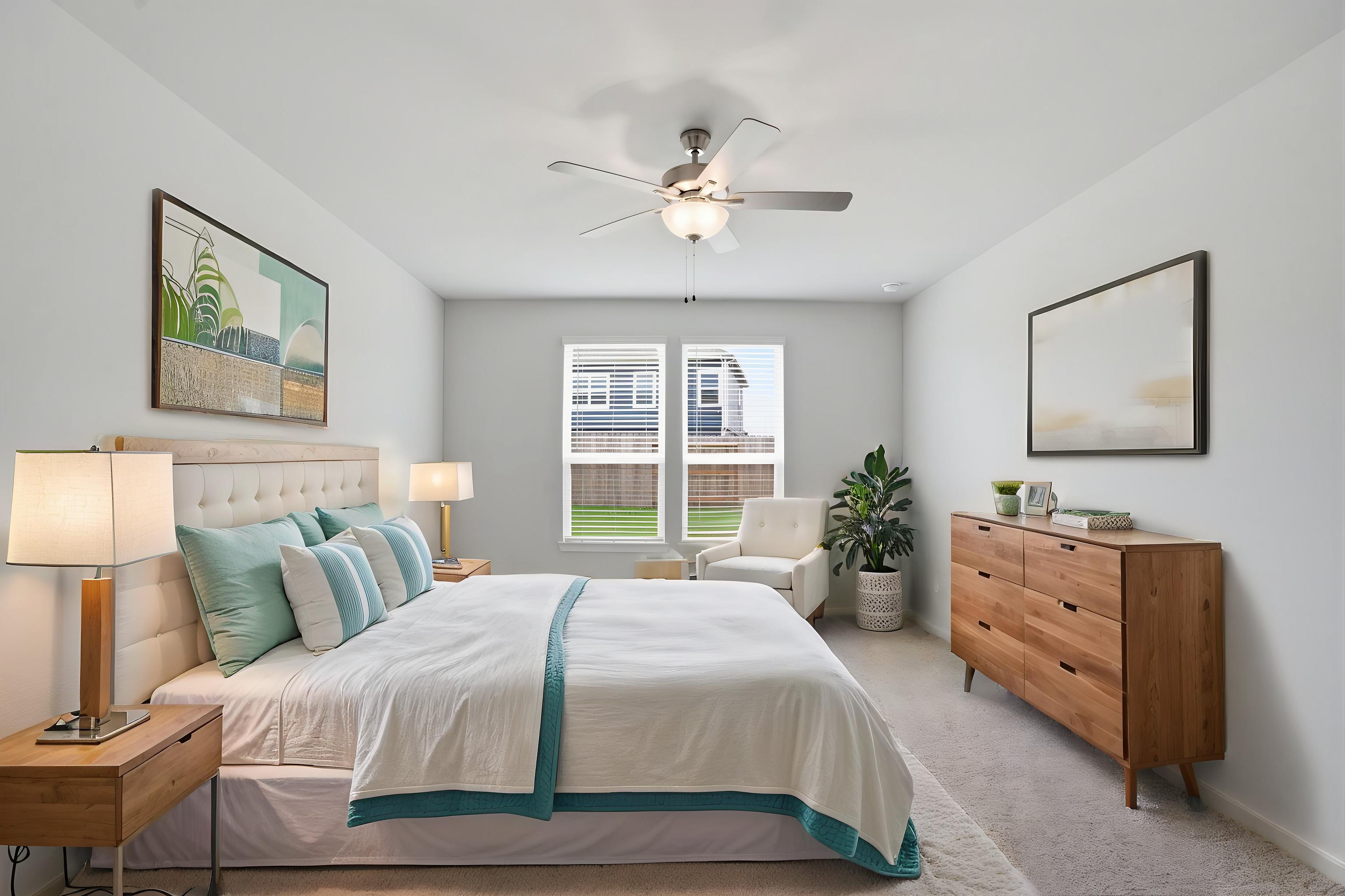 A bedroom with a bed and a fan.