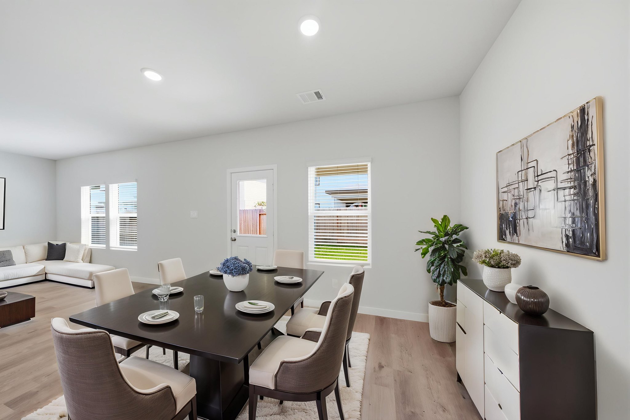 A dining room with a large table.