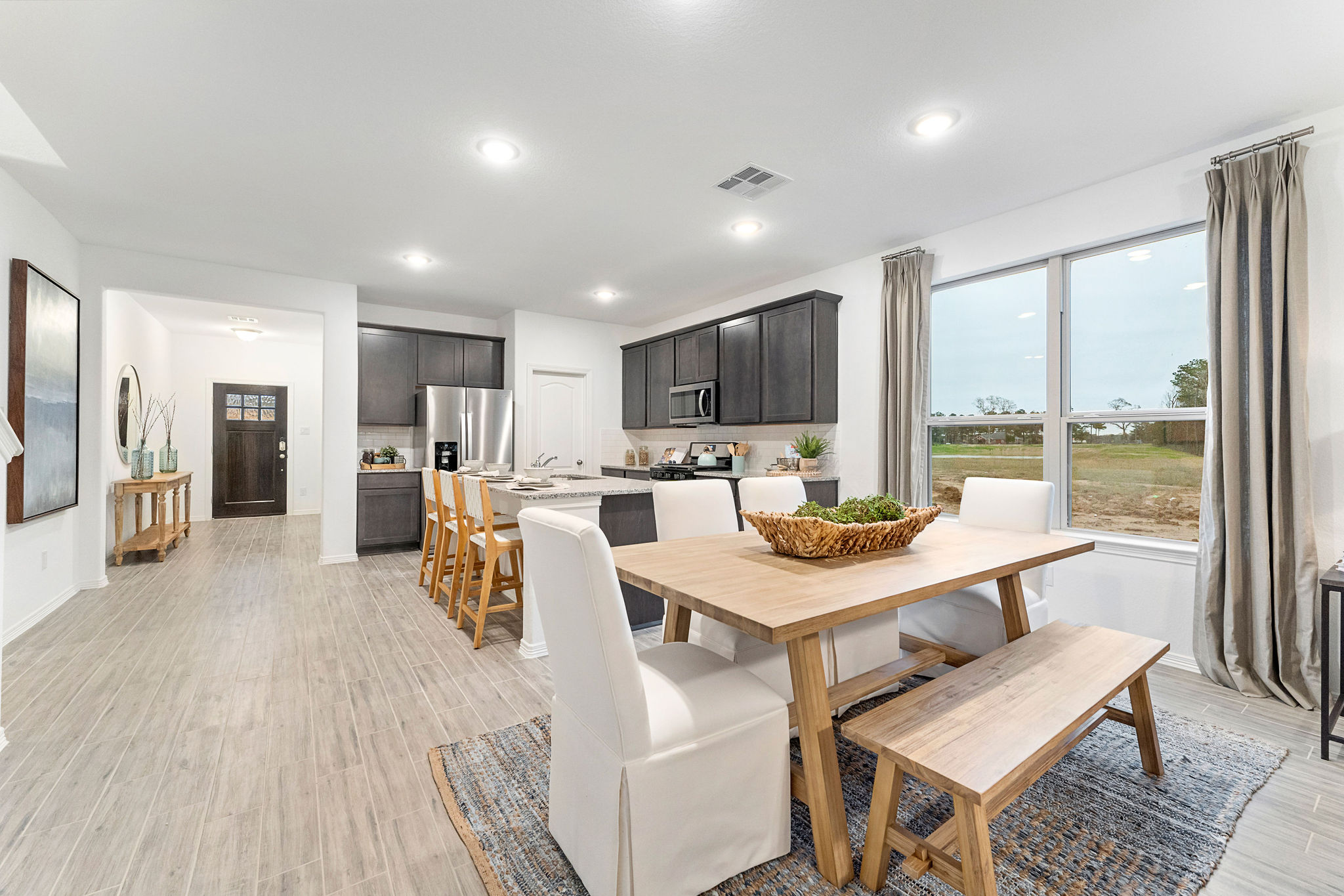 A large kitchen with a dining table.
