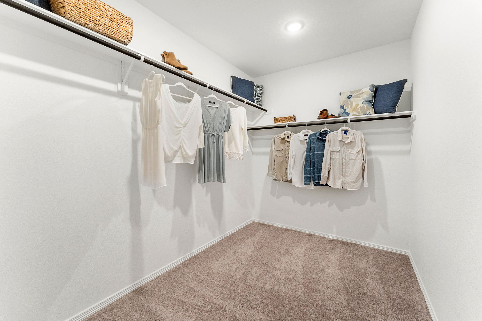 A room with a white wall and a white floor with a white wall with a basket and a.