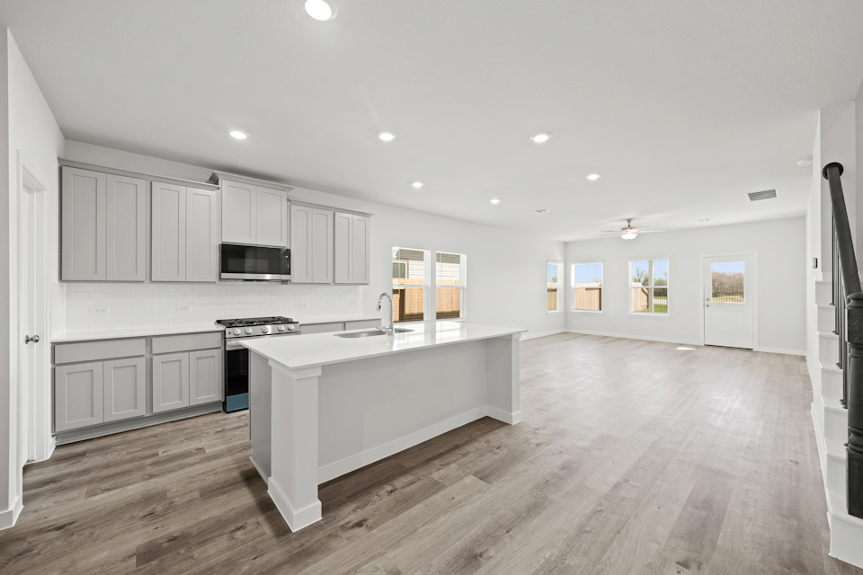 A kitchen with white cabinets.